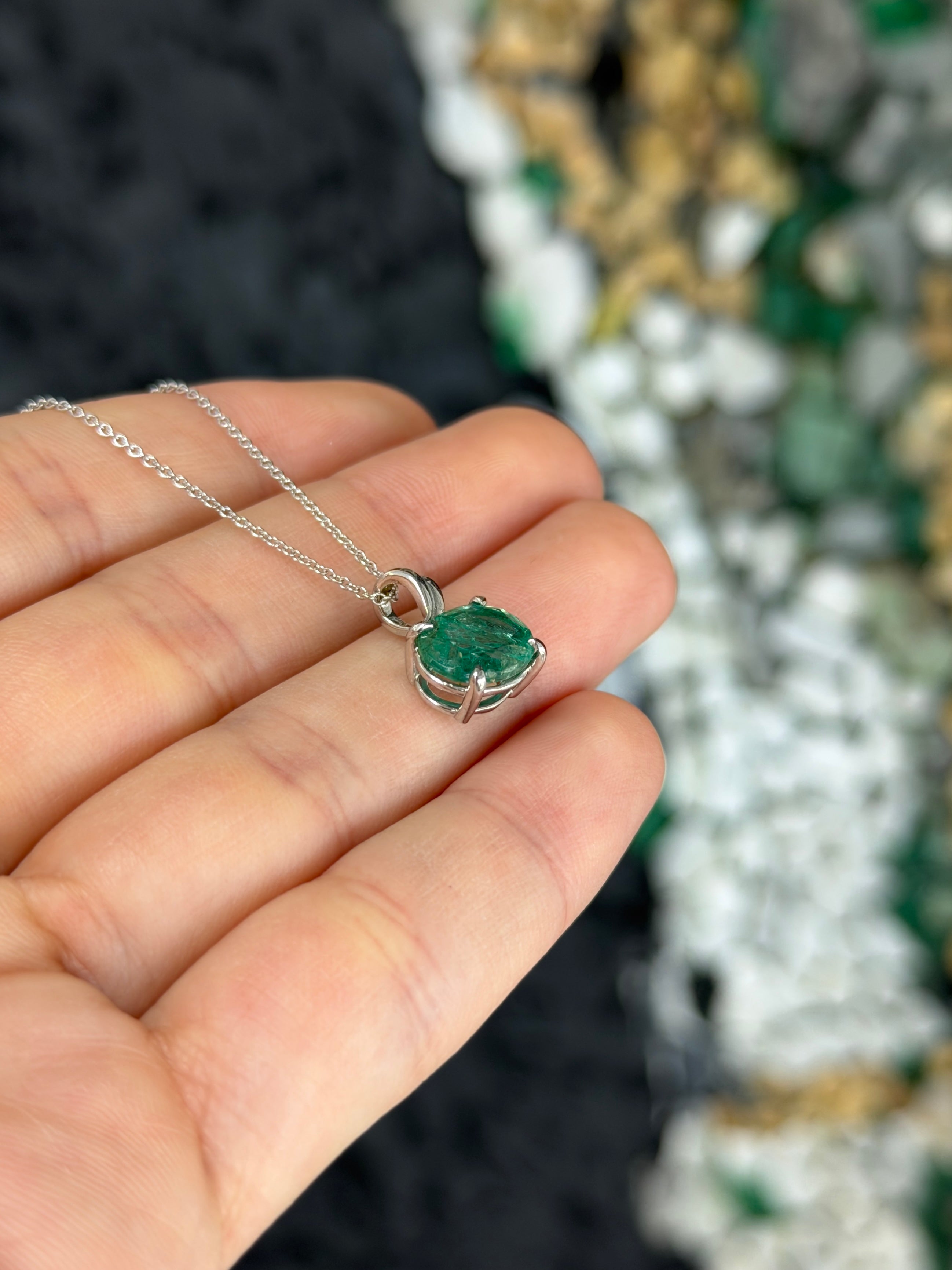 Earthy 2.60ct east-west oval emerald solitaire leaf pendant necklace in 14K white gold, featuring a detailed leaf design.