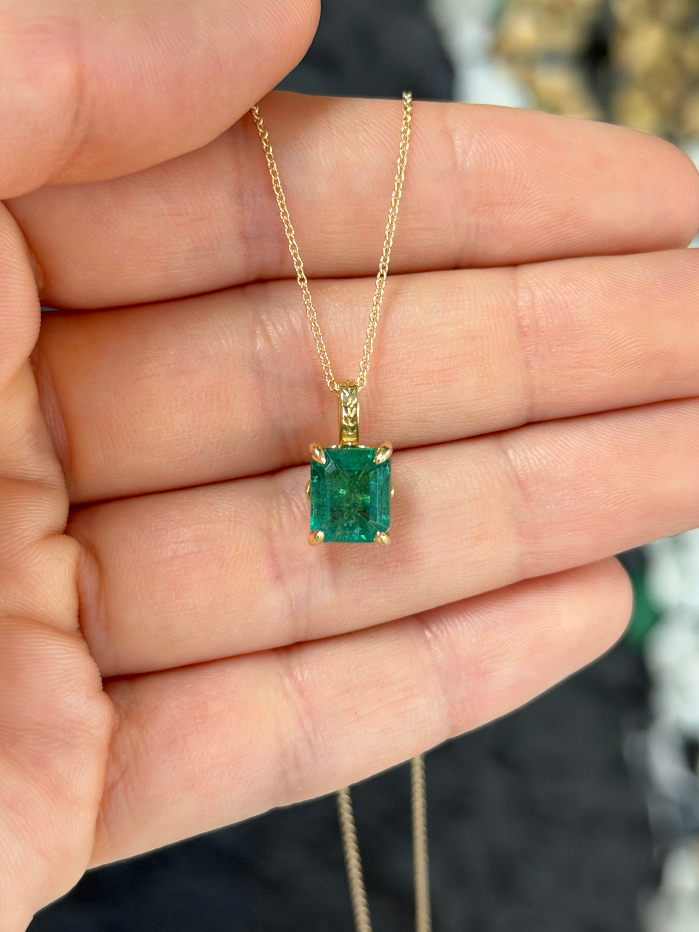14K gold solitaire emerald necklace with a 3.50 carat fleur de lis design, featuring a vibrant emerald gemstone.