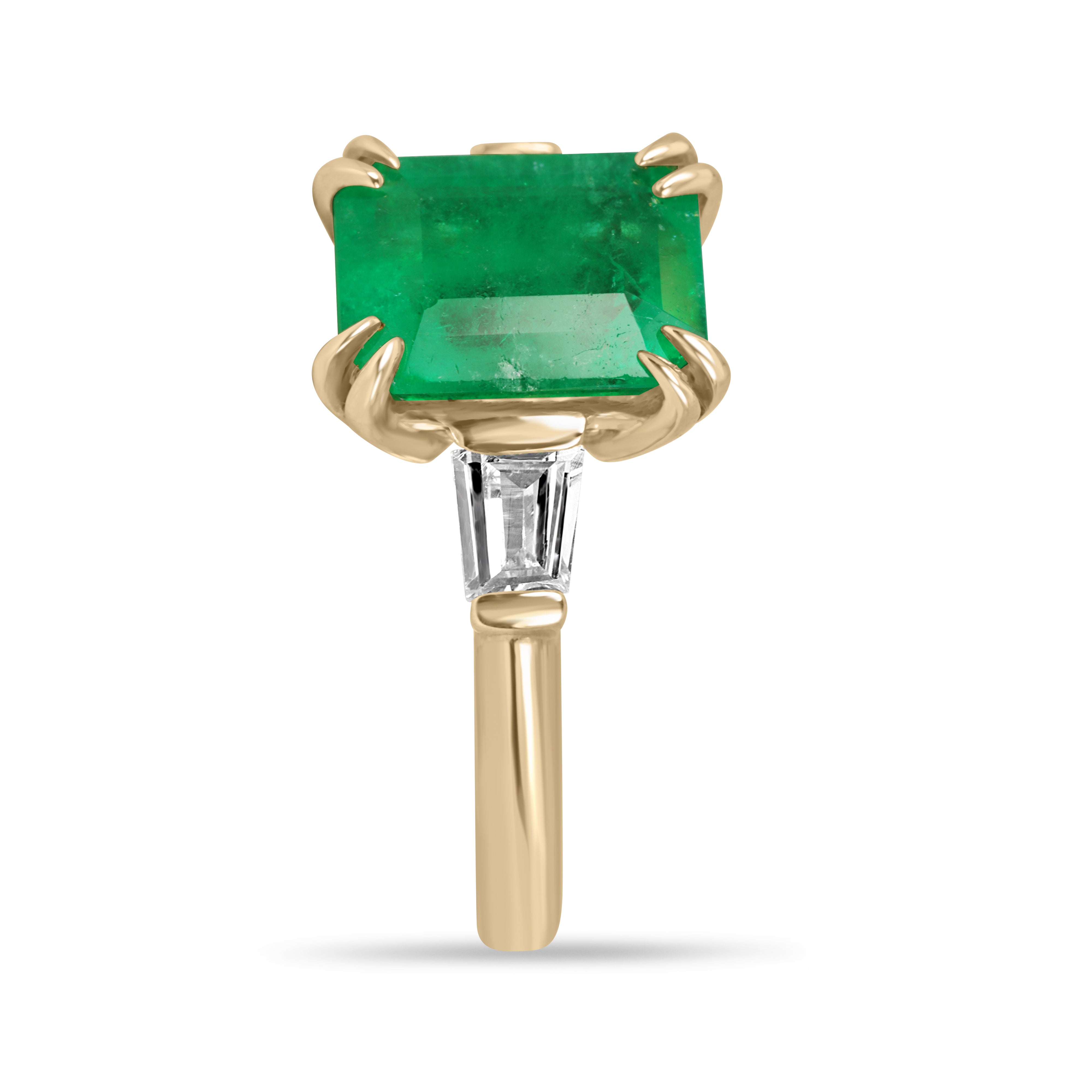 18K gold Colombian emerald and tapered baguette diamond ring with 3.36tcw, featuring a vibrant green emerald centerpiece and sparkling diamonds.