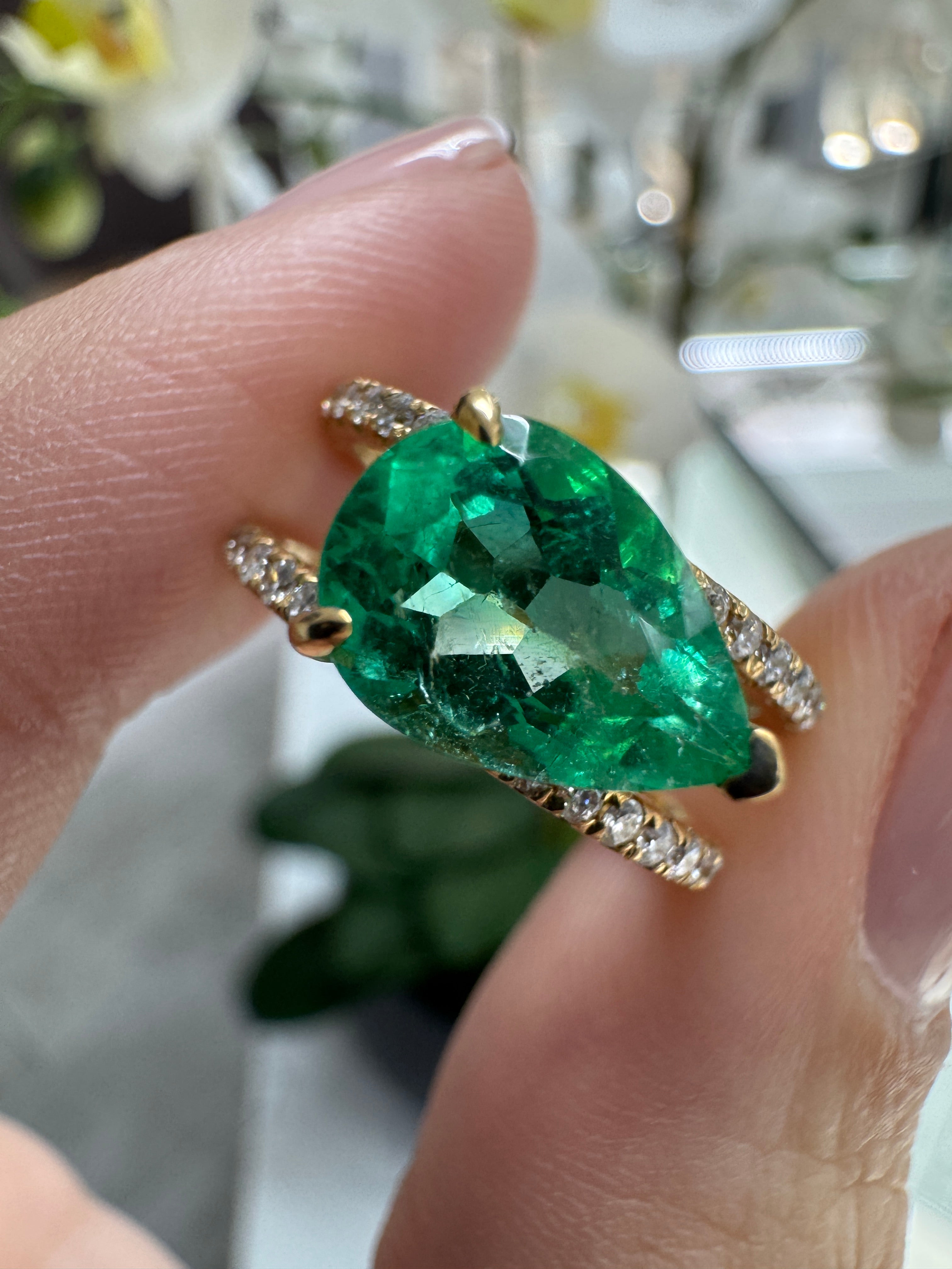 East to West Colombian emerald and diamond wide band ring in 18K gold with split shank design by JR Colombian Emeralds.