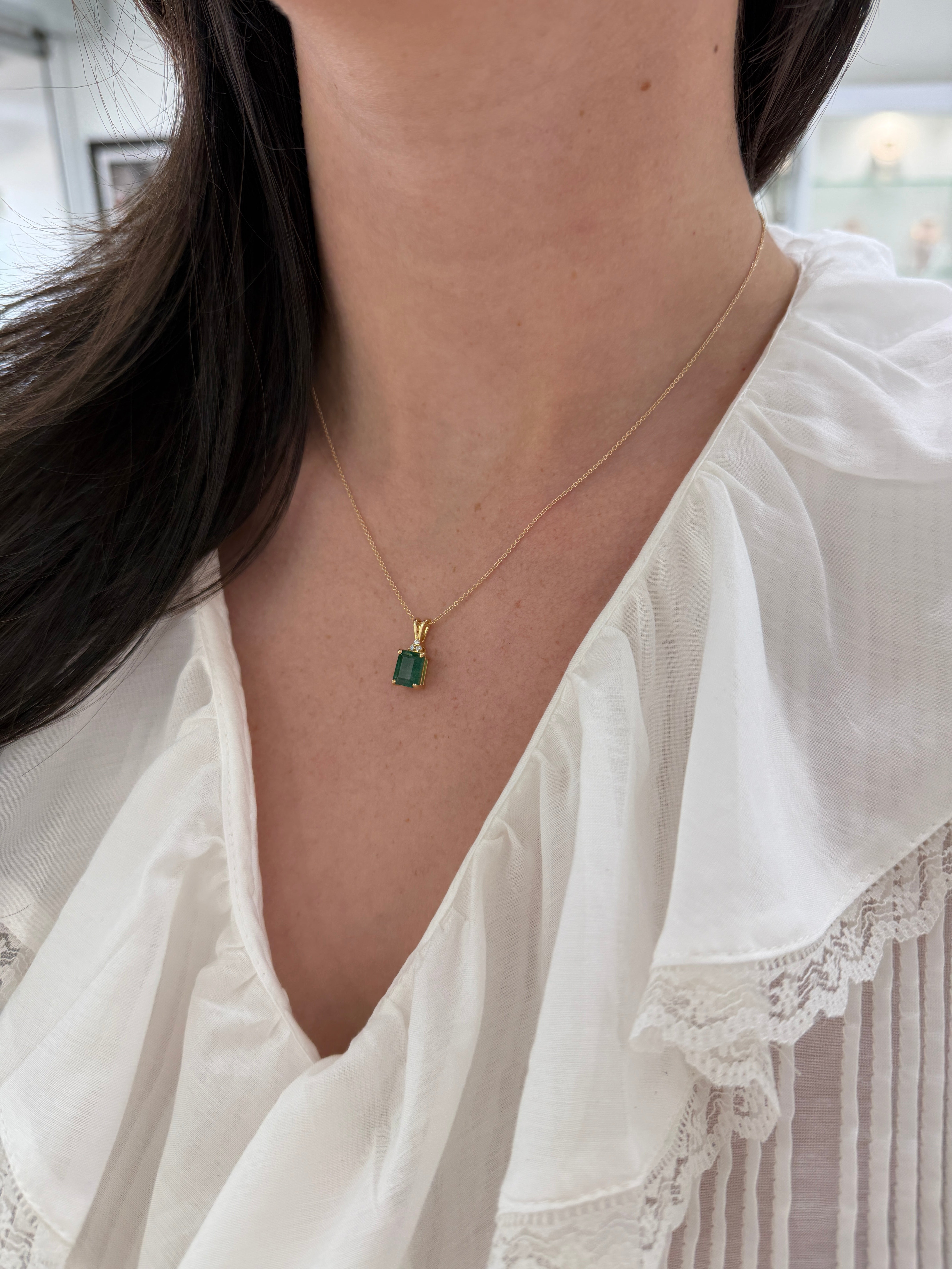 Emerald cut emerald pendant with trefoil diamond accents in 14K gold, featuring a 2.75-carat Colombian emerald by JR Colombian Emeralds.