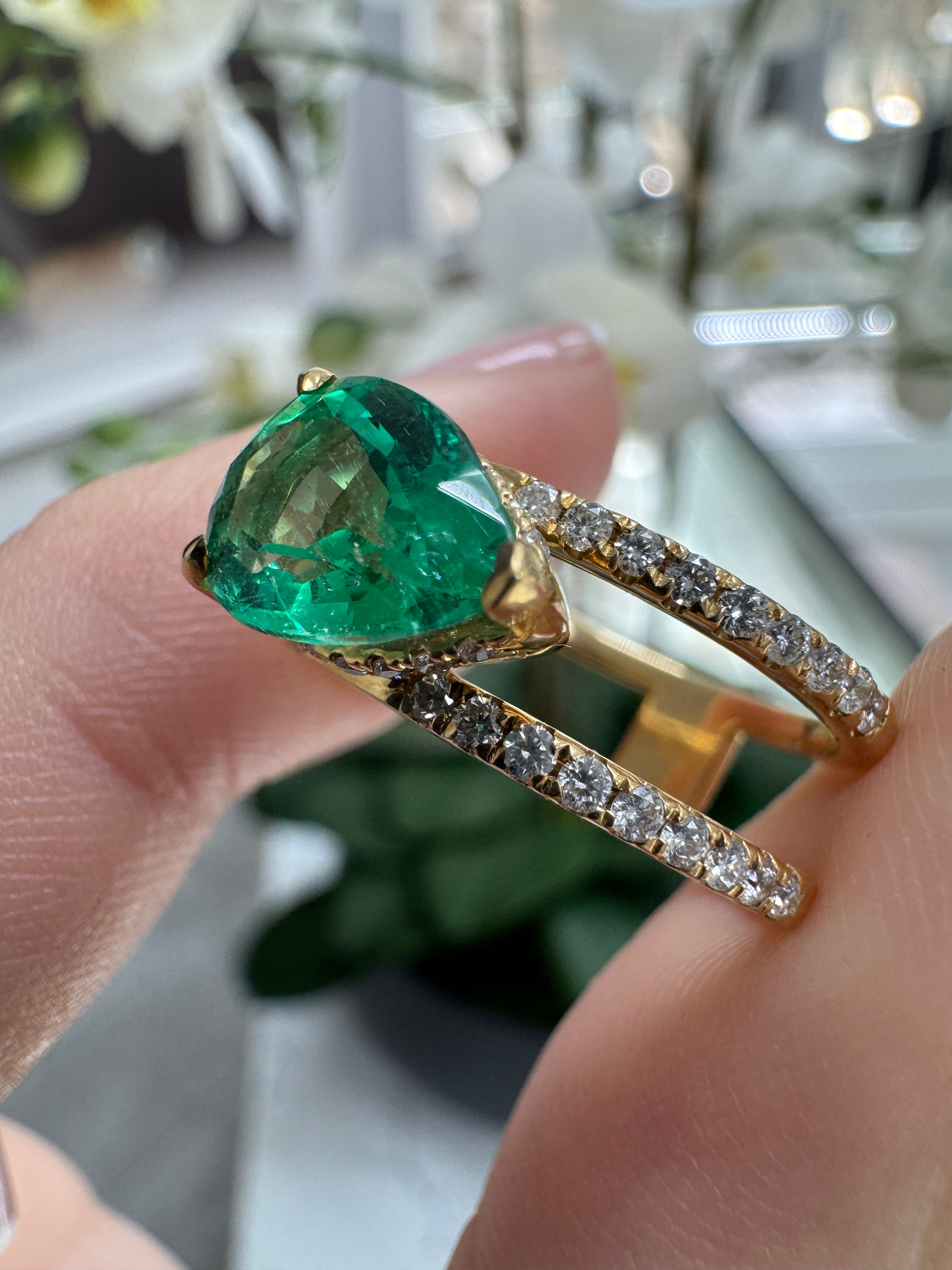 East to West Colombian Emerald and diamond wide band ring in 18K gold with split shank design by JR Colombian Emeralds