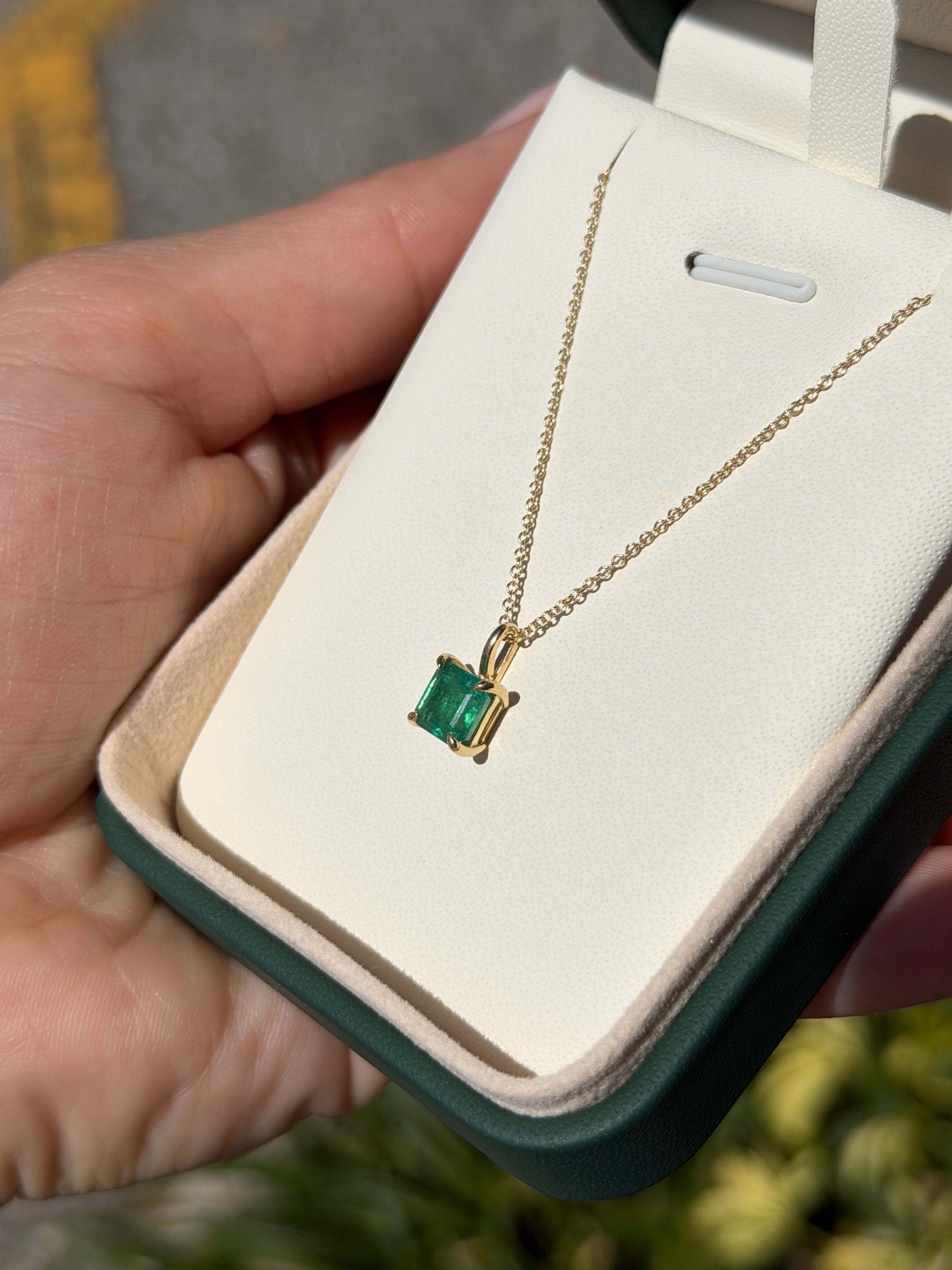 Petite 1.35 Carat Asscher emerald solitaire necklace in 14K gold from JR Colombian Emeralds, showcasing a sparkling emerald centerpiece.