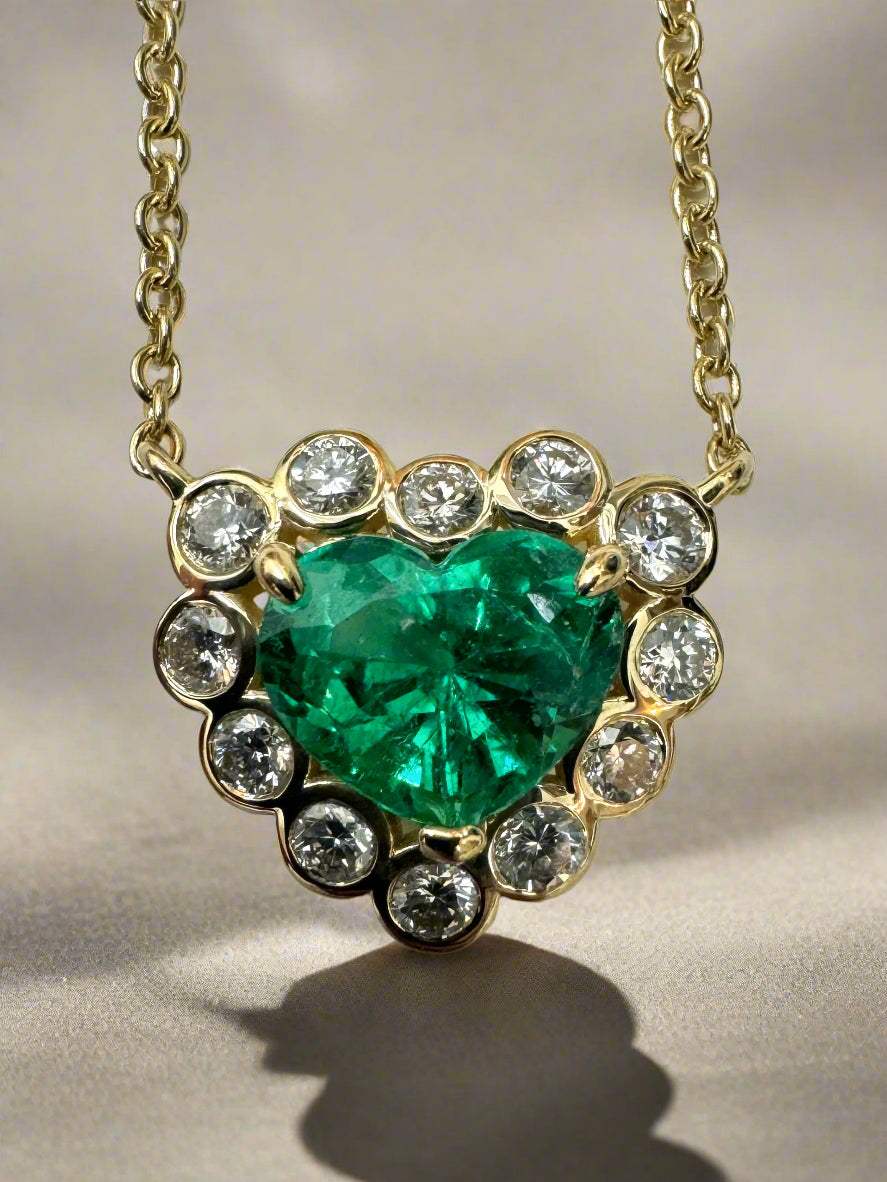 18K yellow gold necklace with a 1.73 carat heart-shaped Colombian emerald and diamond bubble halo.