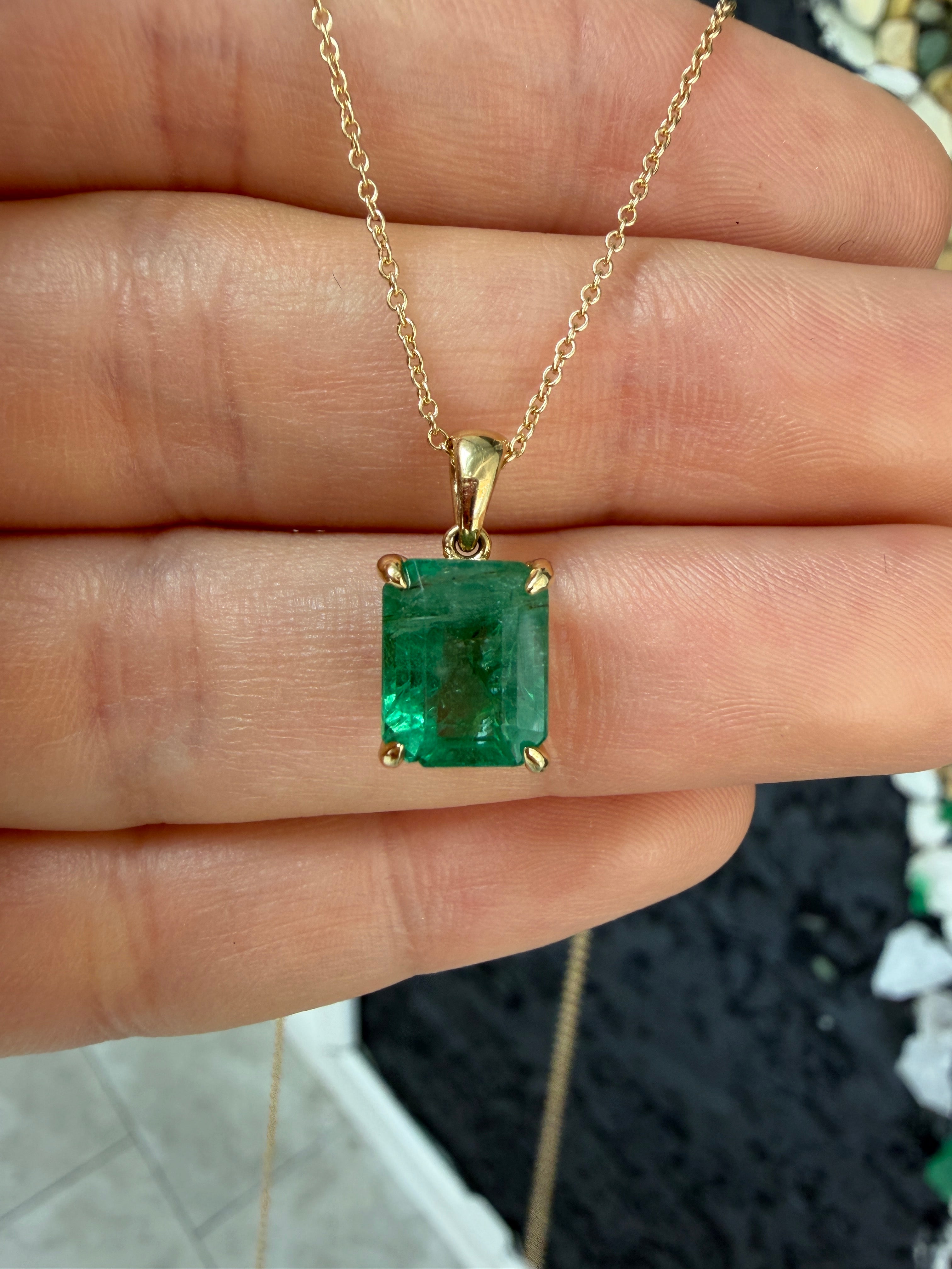 14K gold natural emerald solitaire necklace featuring a 4.25ct earthy Colombian emerald gemstone.