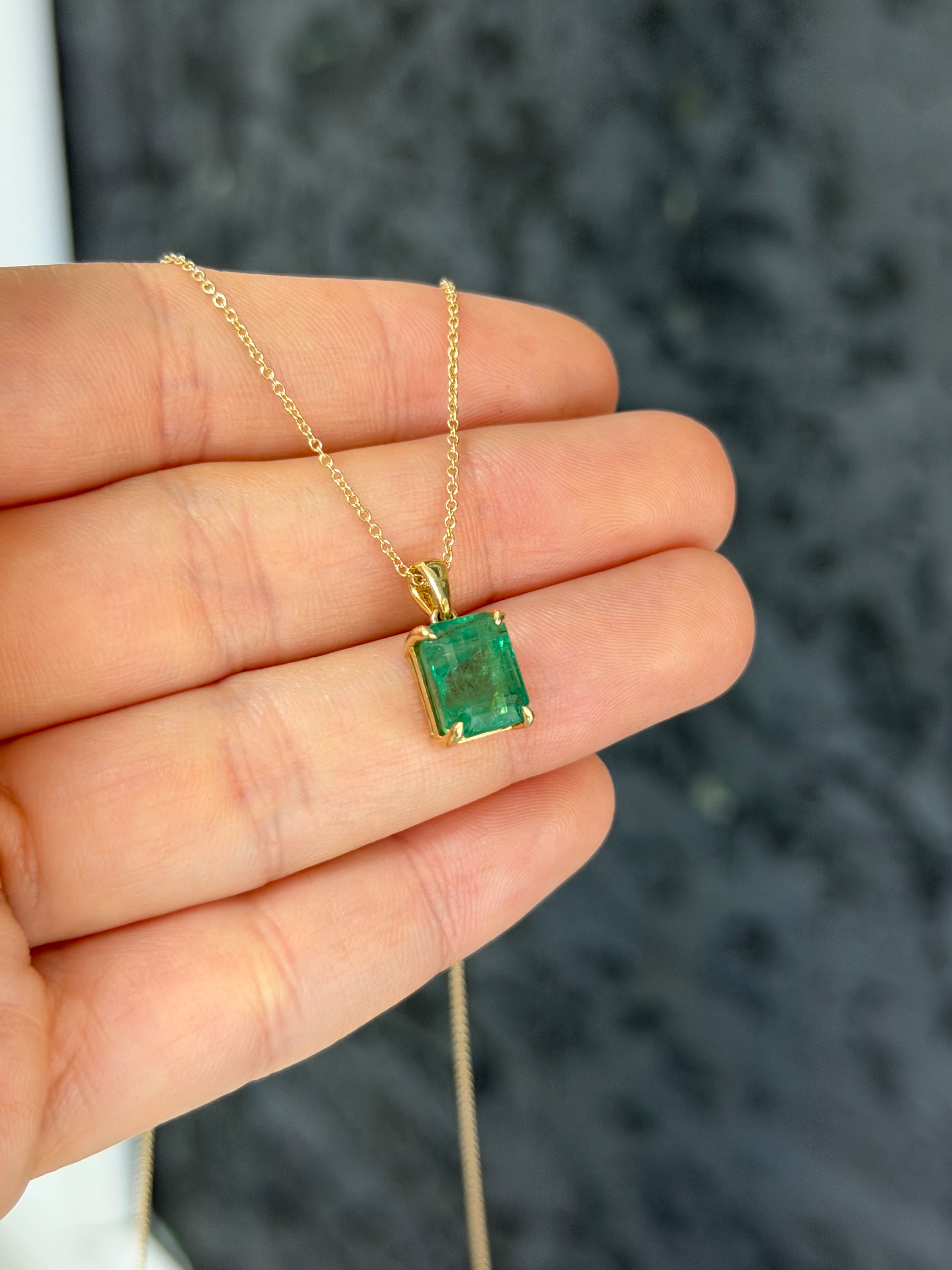 14K gold natural emerald solitaire necklace with a 4.25ct earthy green emerald by JR Colombian Emeralds.