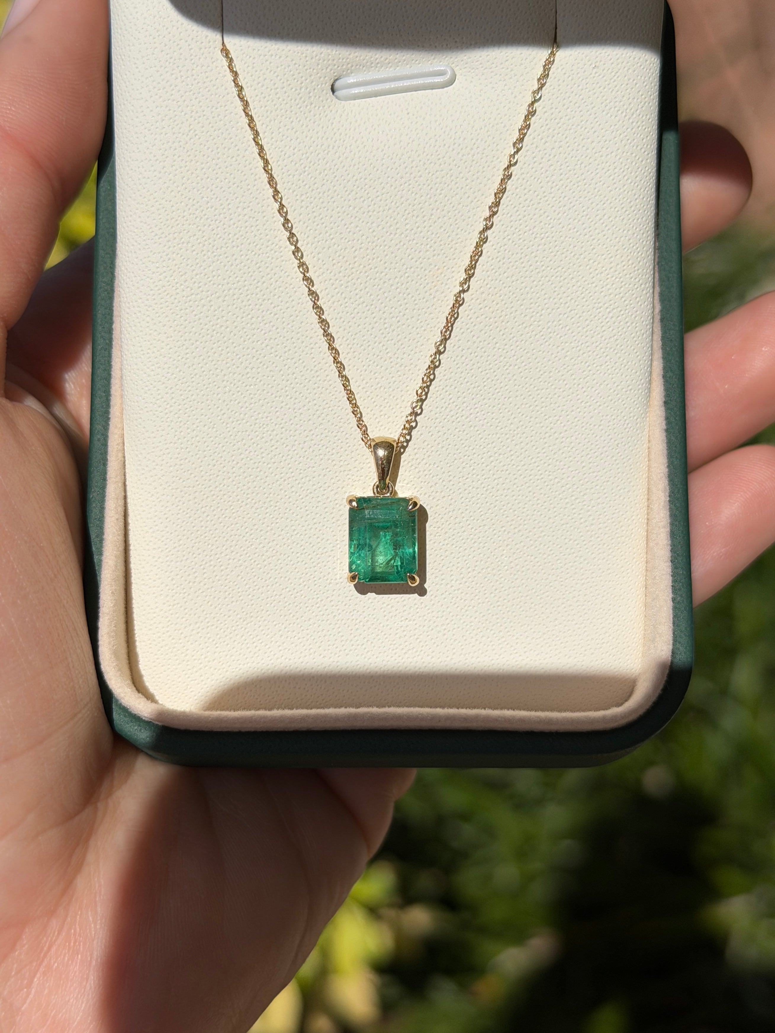 14K gold natural emerald solitaire necklace featuring a 4.25ct earthy Colombian emerald gemstone, elegant and timeless jewelry piece.