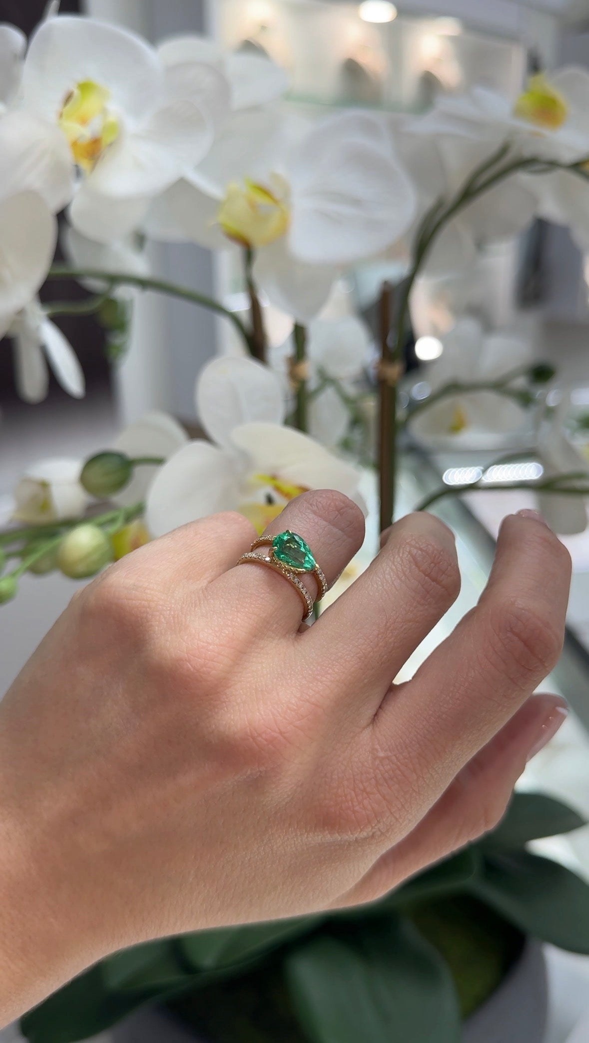 East to West Colombian emerald and diamond wide band ring in 18K gold with split shank design by JR Colombian Emeralds.