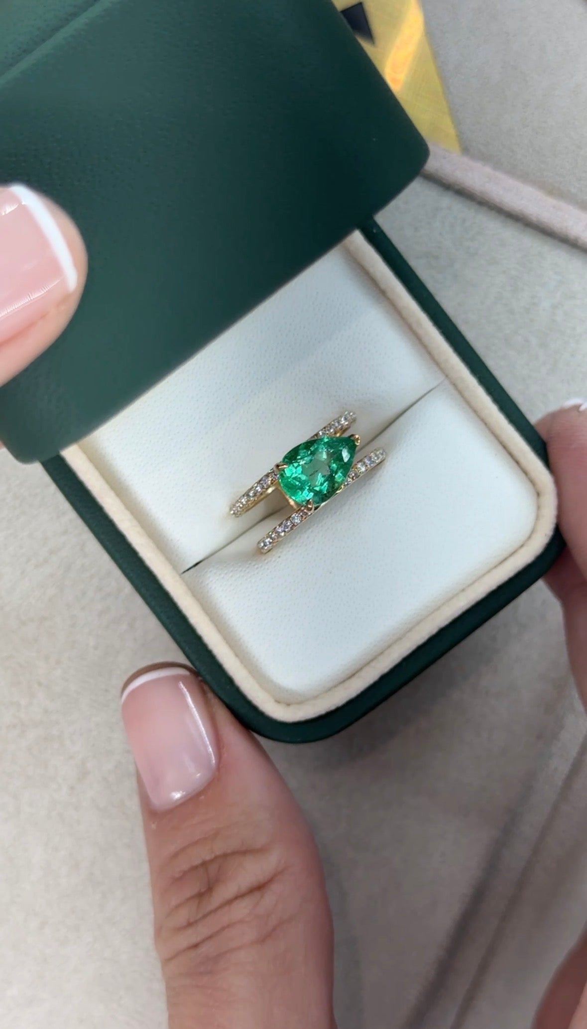 East to West Colombian Emerald and diamond wide band ring in 18K gold by JR Colombian Emeralds, featuring a 2.29tcw split shank design.