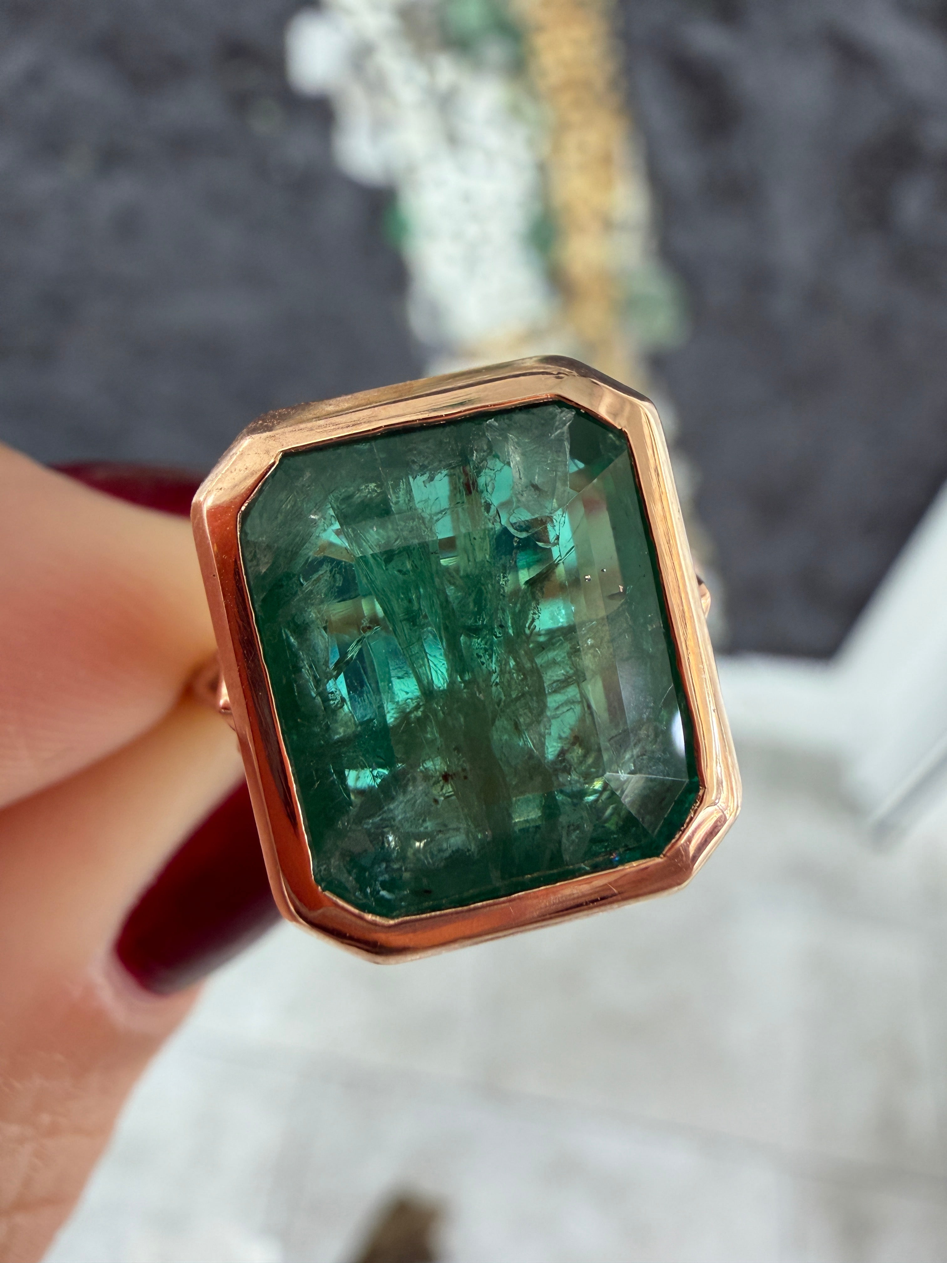 Vintage-inspired emerald bezel ring with diamond shank and scroll basket detail in 14K rose gold by JR Colombian Emeralds.