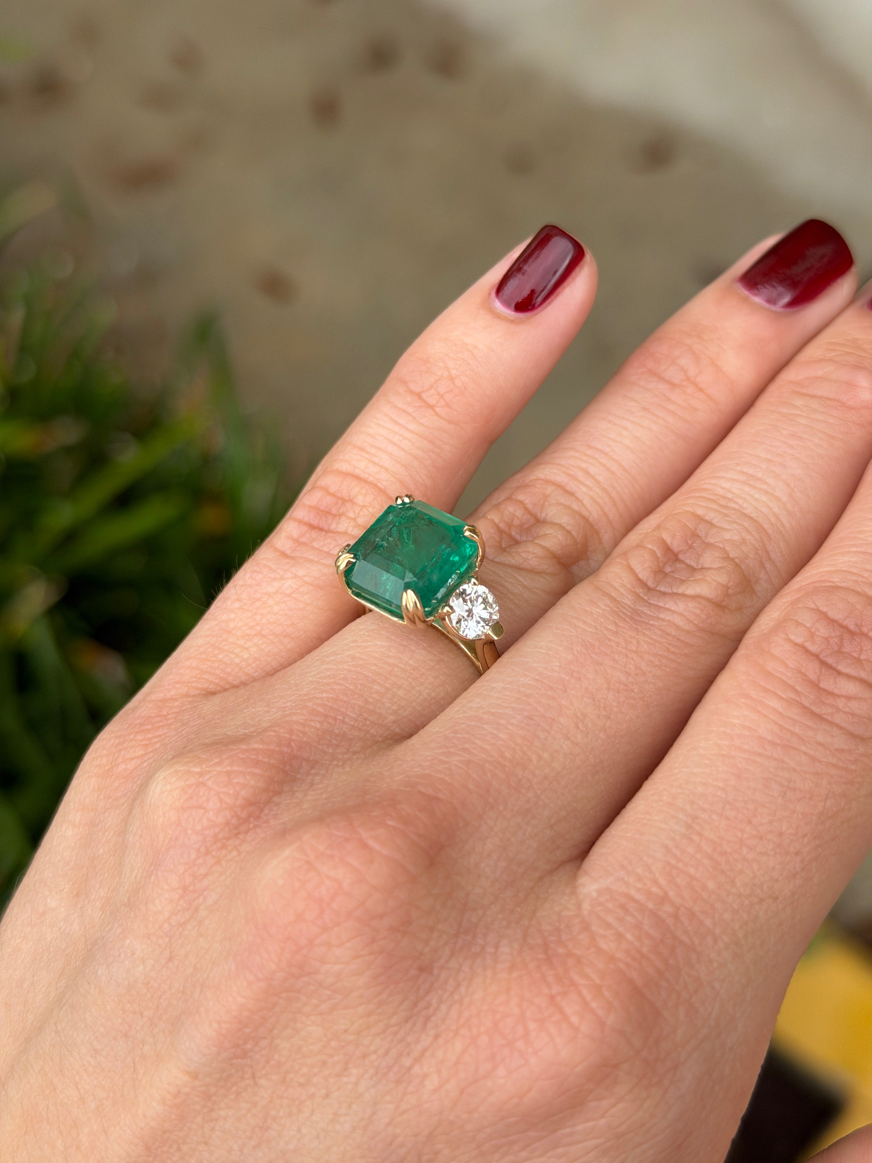 Three stone Asscher cut emerald engagement ring with round lab diamonds in 14K gold cathedral setting by JR Colombian Emeralds.