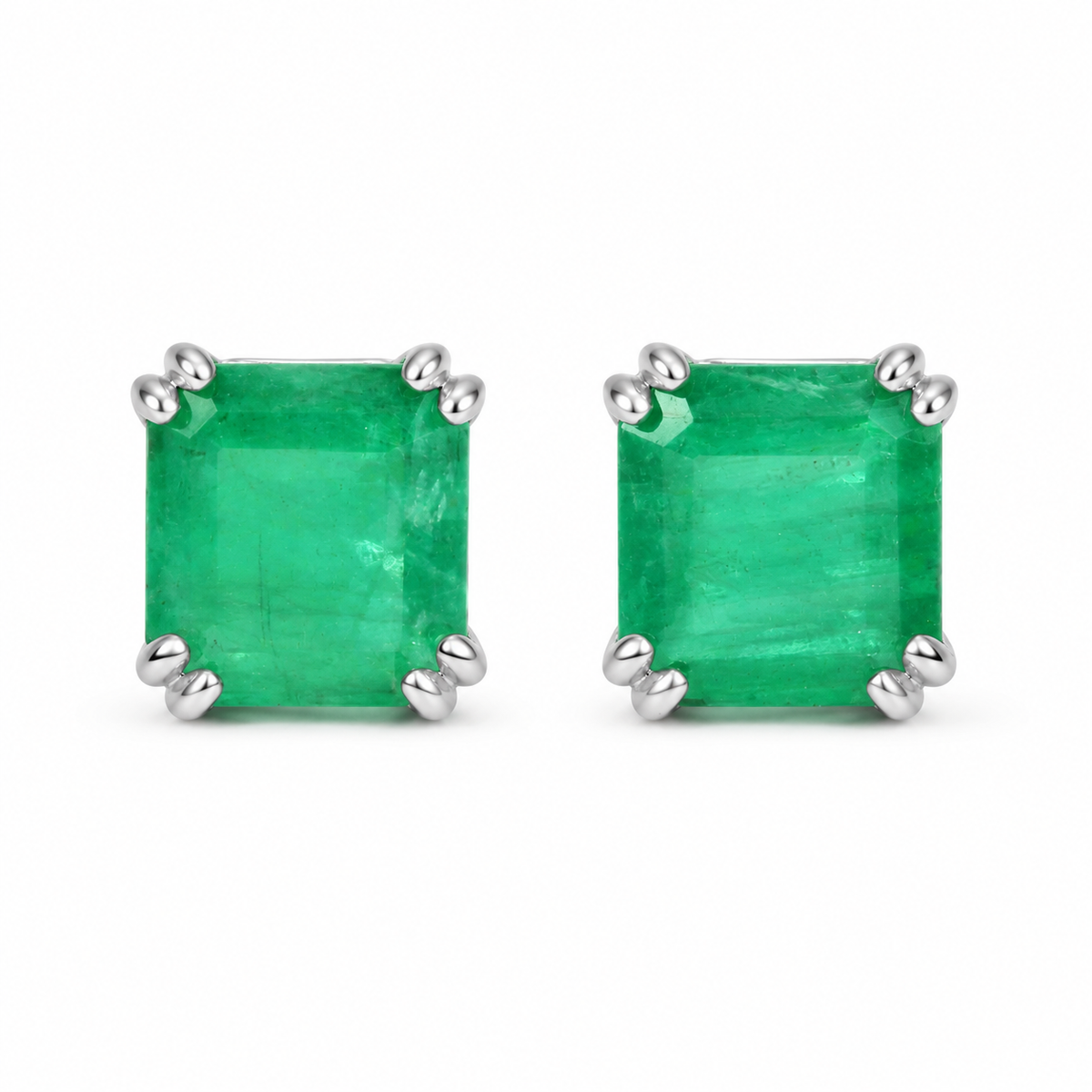Pair of silver 925 emerald stud earrings with natural dark green emeralds, 1.20tcw, featuring double prong settings.