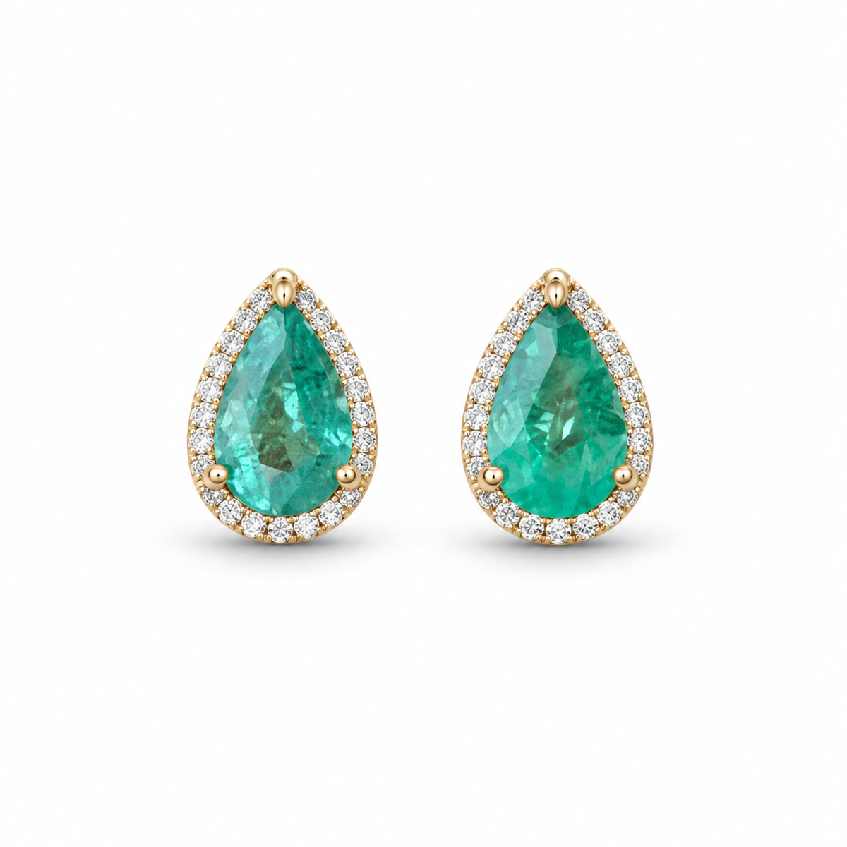Colombian Emerald and diamond pave halo earrings featuring 1.87tcw 14K yellow gold teardrop and pear-shaped emeralds.
