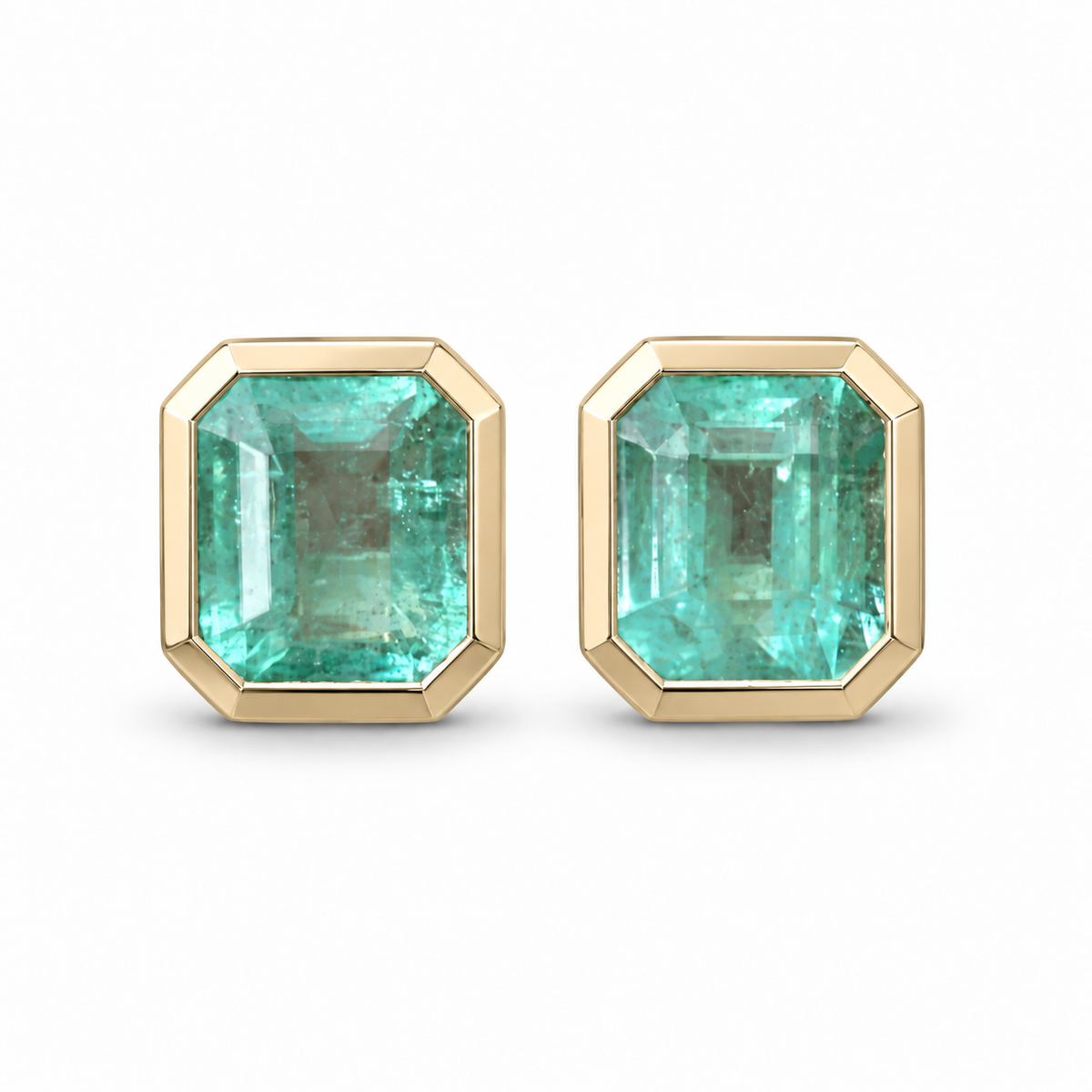 Polished champagne gold stud earrings featuring 6.80tcw natural Colombian emeralds in a bezel setting, by JR Colombian Emeralds.