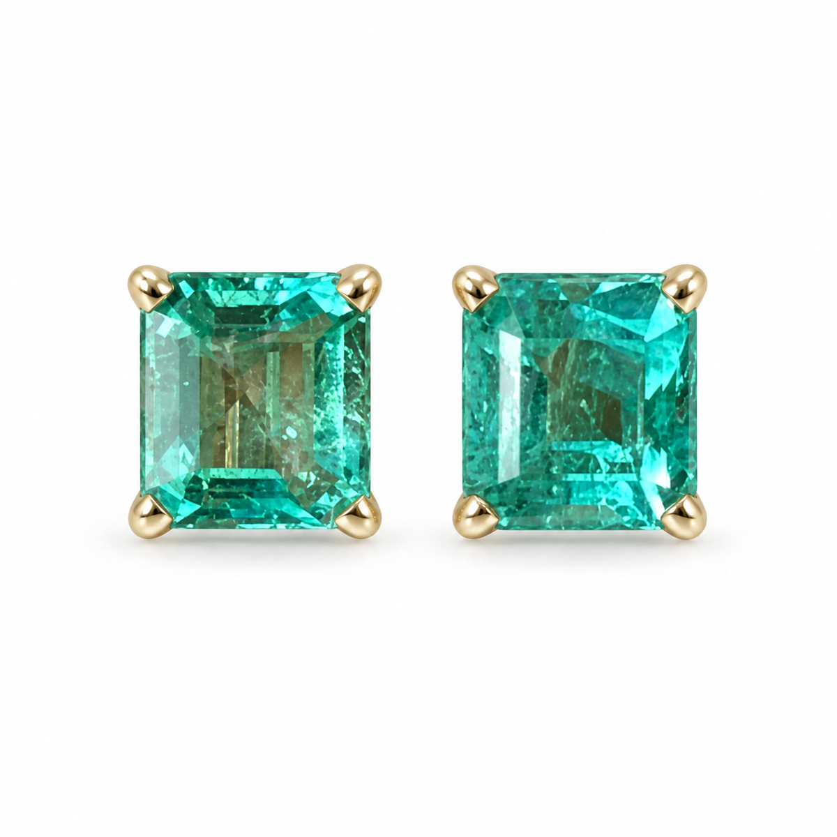 Pair of vibrant Asscher cut Colombian emerald stud earrings in 14K yellow gold, rectangular aqua-green gemstone jewelry.