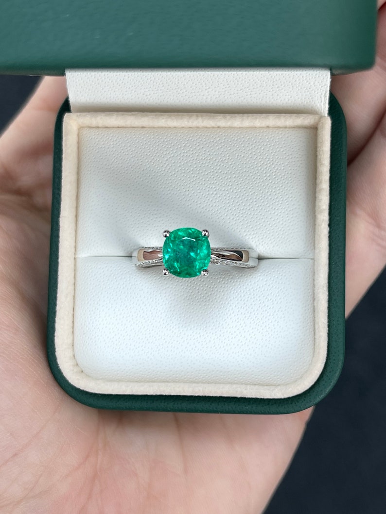 18K white gold engagement ring with 2.44tcw cushion-cut emerald and diamond accents, featuring Colombian Emerald branding.