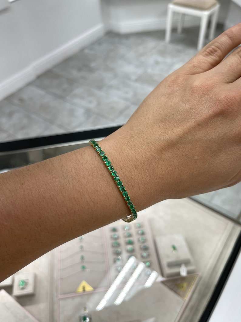 Medium dark green round cut emerald tennis bracelet featuring Colombian Emerald brand, 14K unisex jewelry with 6.0 tcw gemstones.