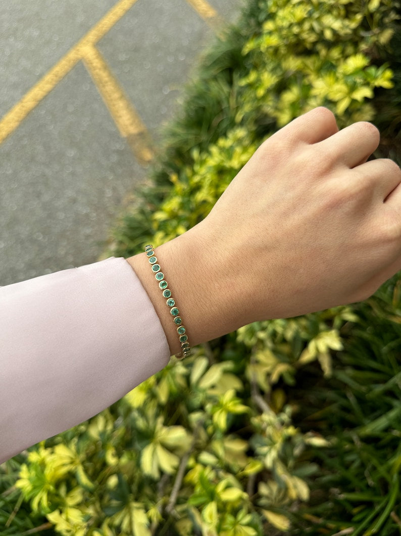 14K gold unisex emerald tennis bracelet with round cut green emeralds, 9.40 tcw, bezel setting, Colombian Emerald brand.