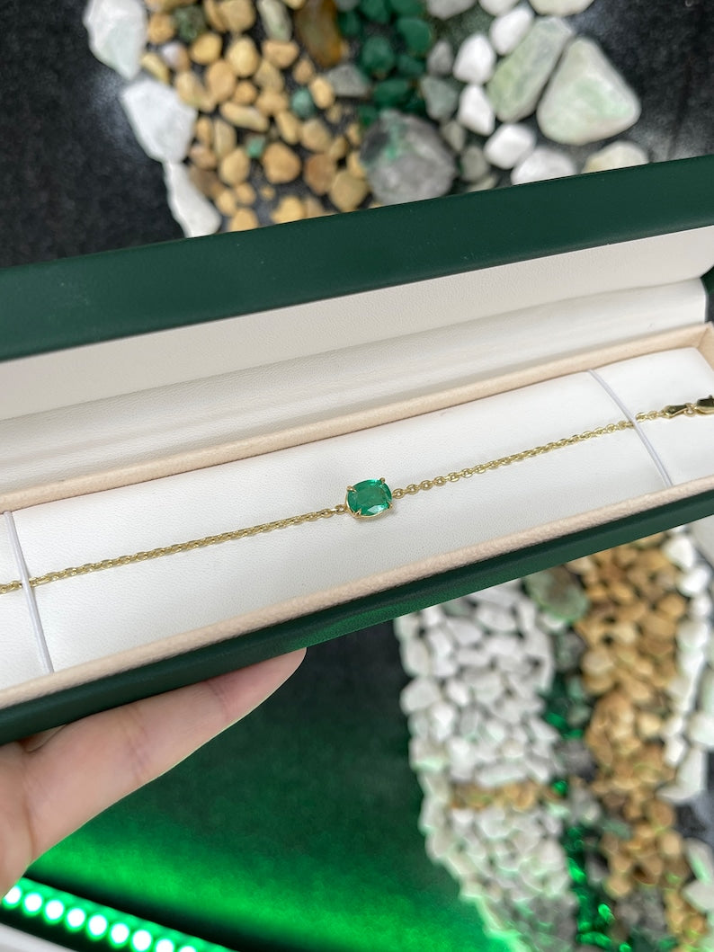 Unisex 2.0ct Colombian Emerald bracelet featuring a vivid medium dark green oval cut emerald in a 14K gold four-prong setting on a 3mm chain.