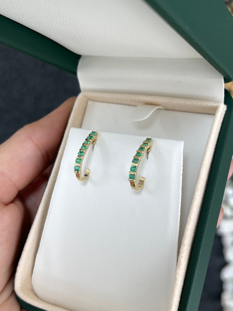 Natural round emerald half J-hoop earrings in 14K gold with 0.75 carats from Colombian Emerald brand.