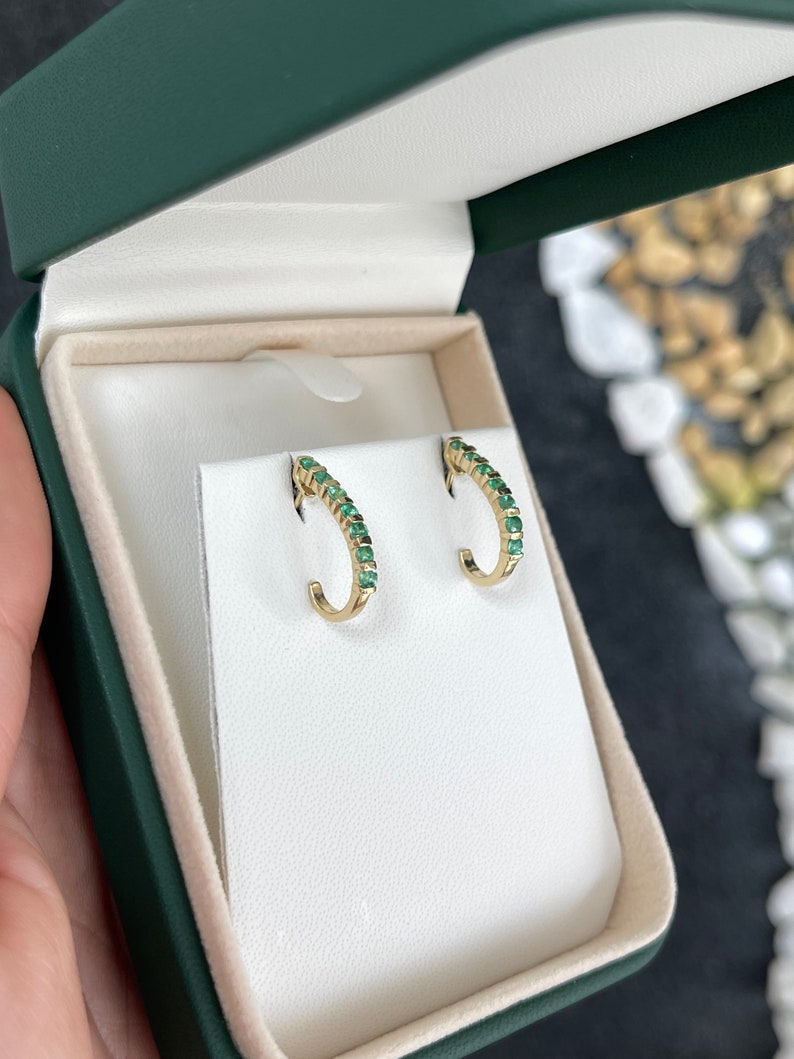 Natural round emerald half J-hoop earrings in 14K gold with 0.75 carats from Colombian Emerald brand.