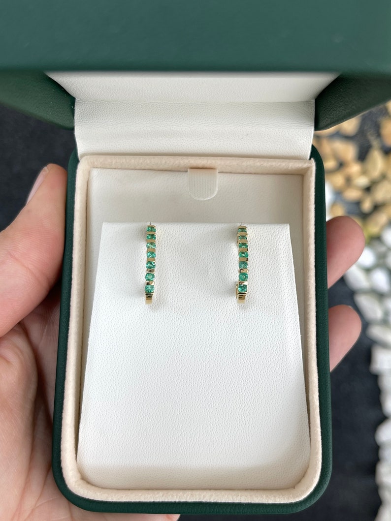 Natural round emerald half J-hoop earrings in 14K gold featuring 0.75tcw Colombian emeralds and a stylish hoop design.