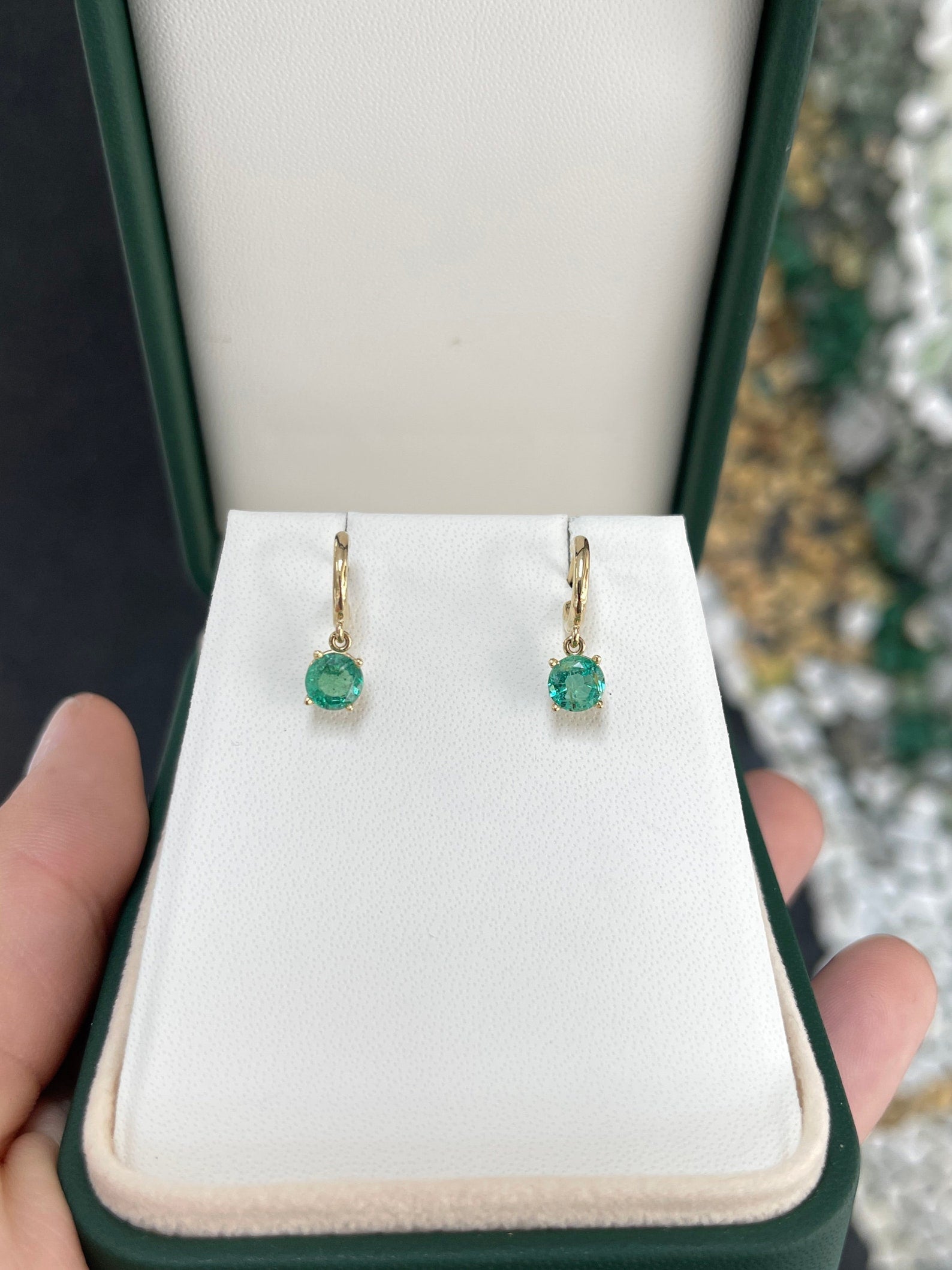 Medium dark green emerald round cut hoop earrings with four prongs in 14K gold, from Colombian Emerald.