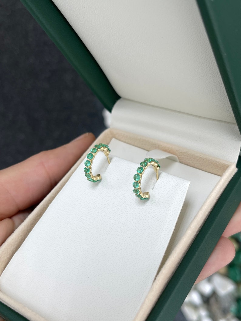 Colombian Emerald 14K yellow gold half hoop huggie earrings with round cut green emeralds and prong setting, 1.50tcw.