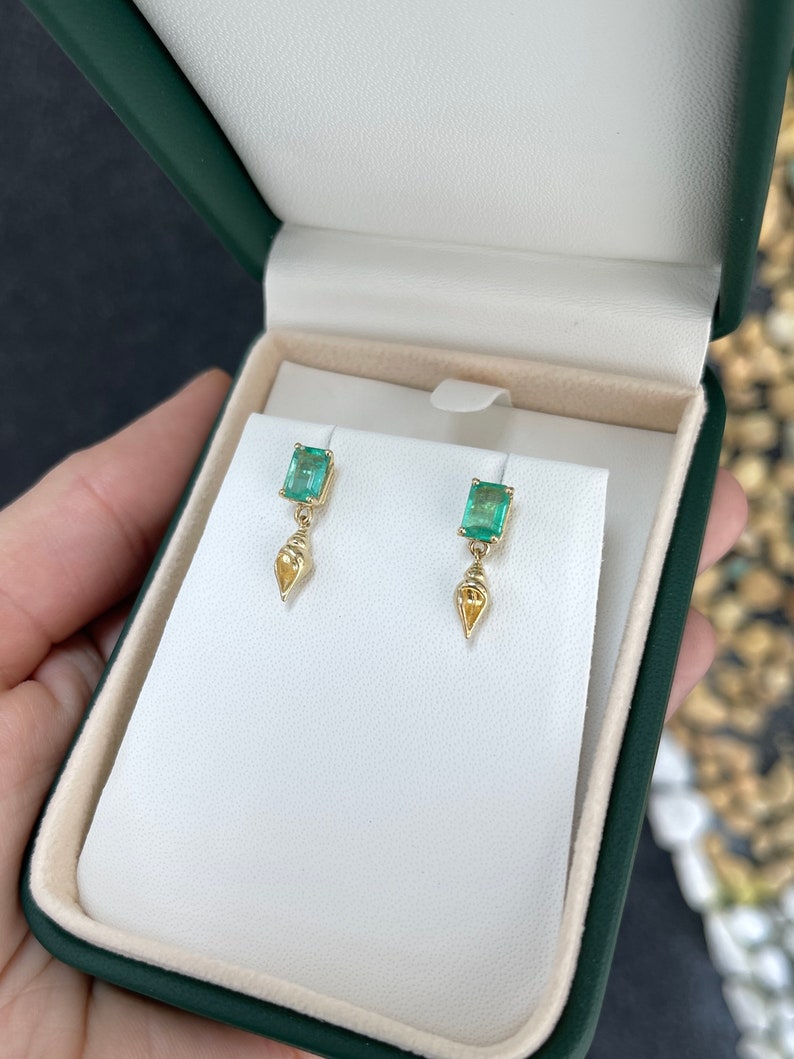 14K gold emerald and tuba sea shell dangle earrings with natural green emeralds and sea shell accents, handcrafted jewelry.