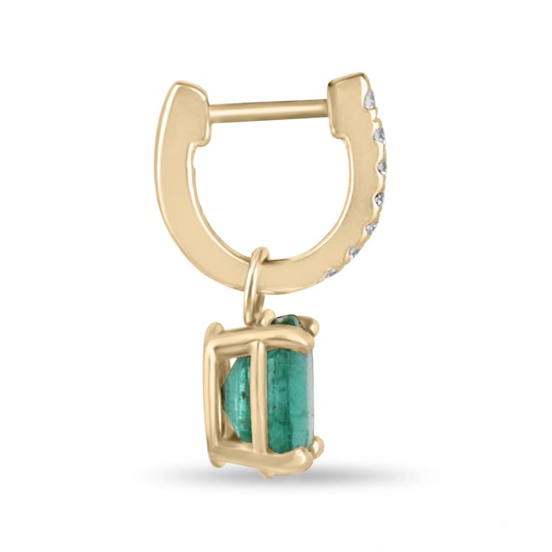 Lush green emerald and diamond accent dangle earrings in 14K gold, featuring oval cut emeralds from Colombian Emerald brand.