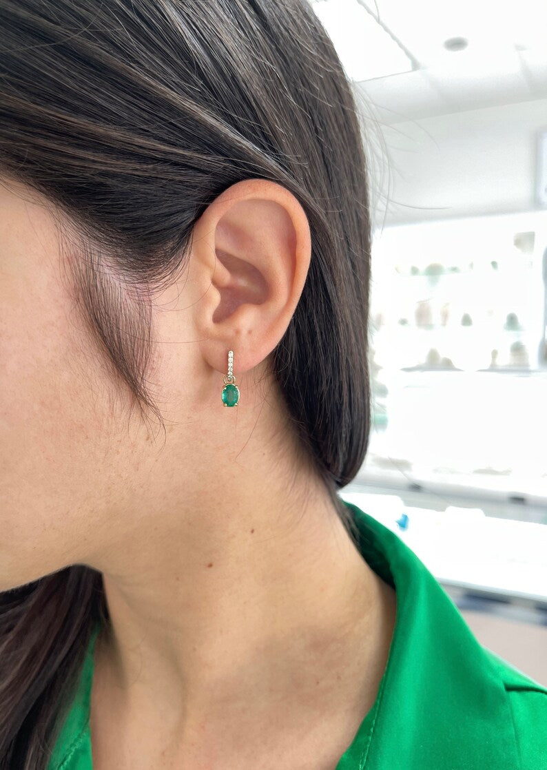 Colombian Emerald 2.0tcw oval cut green dangle earrings with diamond accents in 14K gold setting