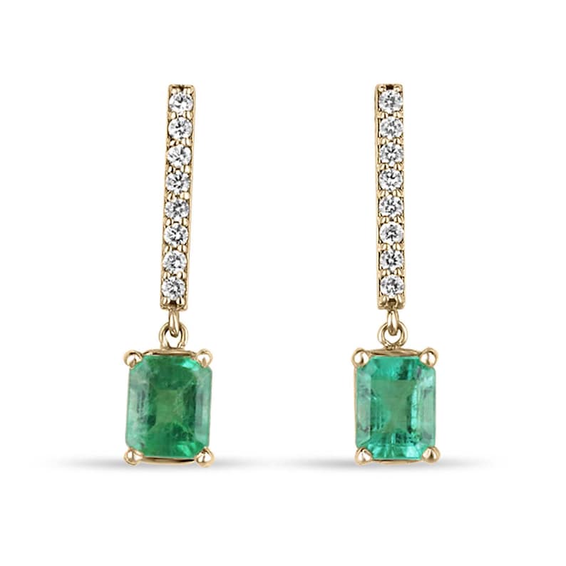14K gold dangle earrings with natural emeralds and pave diamonds, featuring a bar design from Colombian Emerald brand.