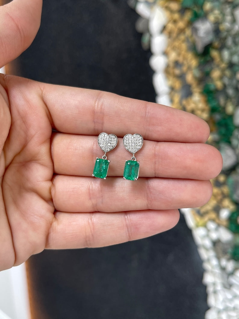 Colombian Emerald and diamond heart cluster dangle earrings in 14K yellow gold with 3.20tcw natural rich medium green emeralds.