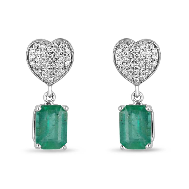 Colombian Emerald and diamond heart cluster dangle earrings in 14K yellow gold with rich medium green emeralds and sparkling diamonds.