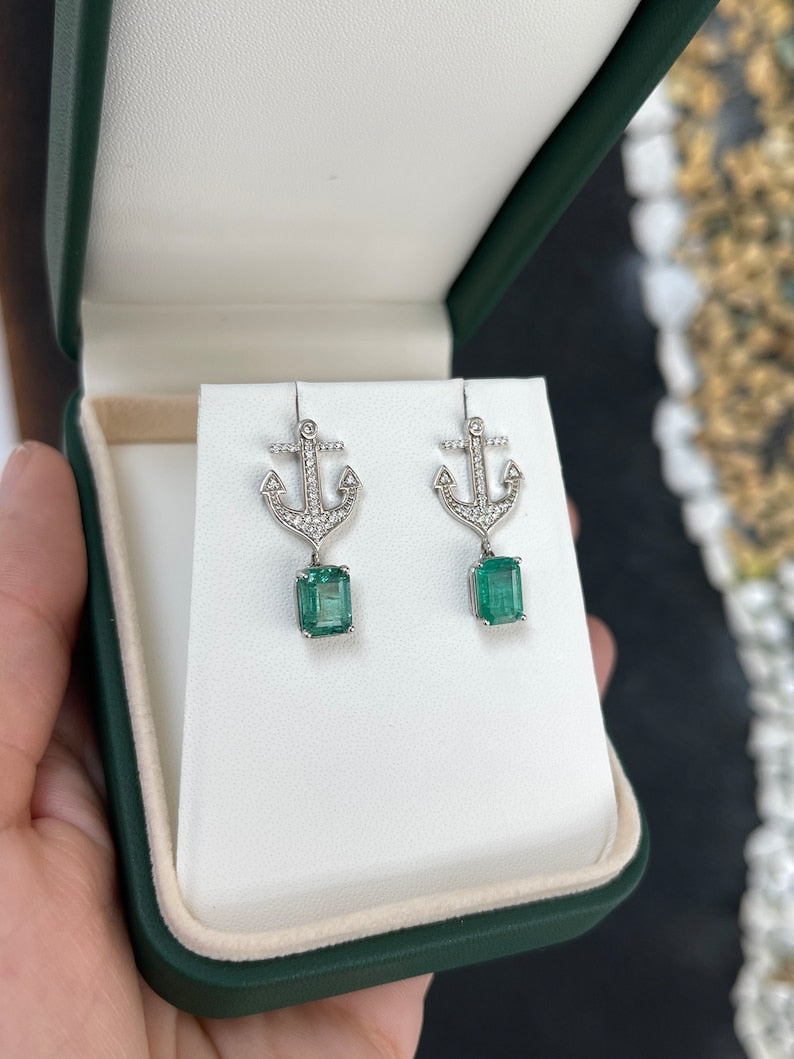 14K gold emerald and diamond anchor dangle earrings featuring lush green Colombian emeralds and sparkling diamonds.