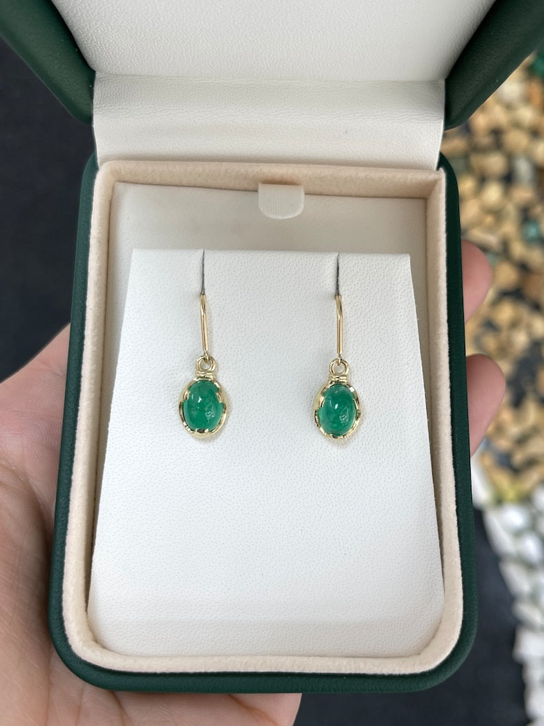 Natural oval cabochon emerald solitaire dangle earrings in 14K gold with ear wires from Colombian Emerald, showcasing elegant jewelry design.
