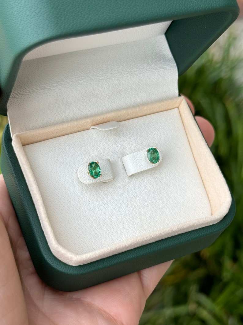 Colombian Emerald 0.80ctw 14K gold petite oval cut four-prong children’s emerald stud earrings, showcasing vibrant green gemstones.