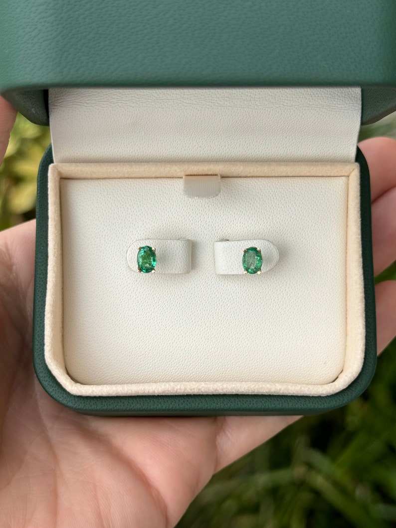 Colombian Emerald earrings with 0.80tcw petite oval cut four-prong settings in 14K gold, suitable for children or delicate wear