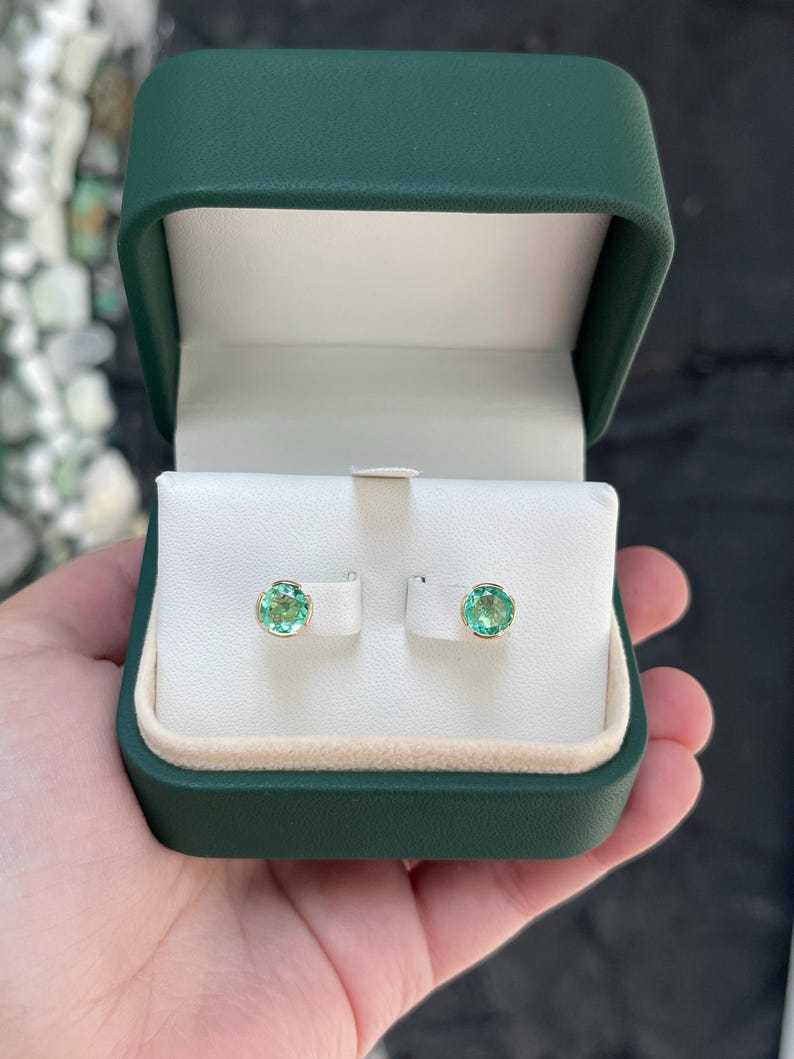 14K Colombian Emerald round stud earrings with semi-bezel setting, featuring 2.0 tcw of vibrant green gemstones.