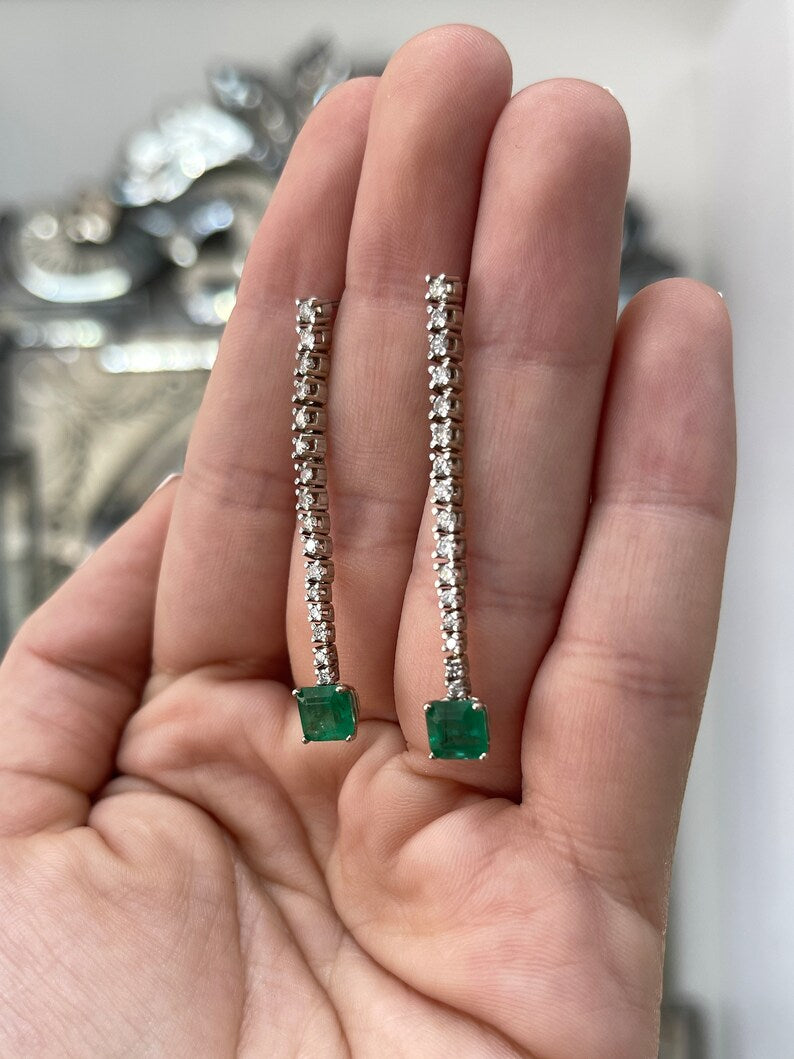 14K white gold dangle earrings with dark green asscher cut emeralds and diamonds from Colombian Emerald.