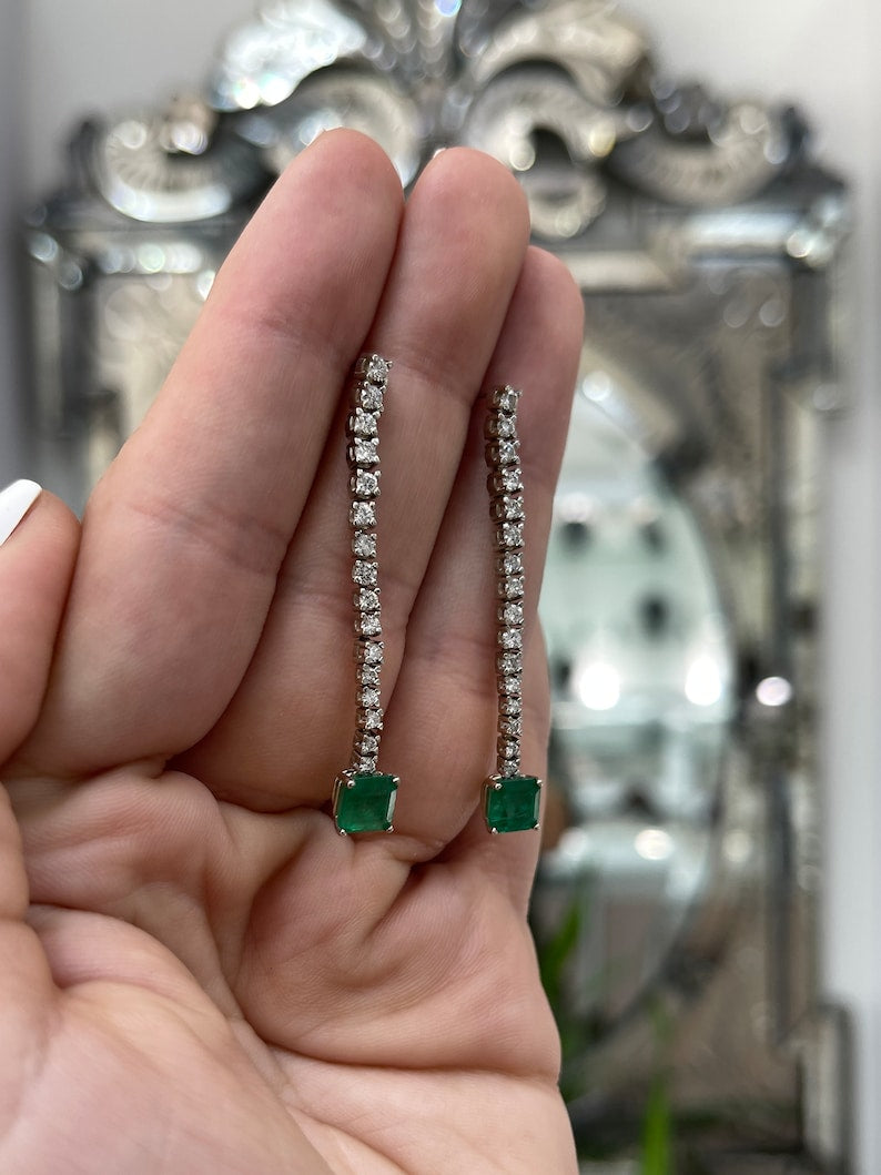 14K white gold dangle earrings with dark green asscher cut emeralds and diamond accents from Colombian Emerald.