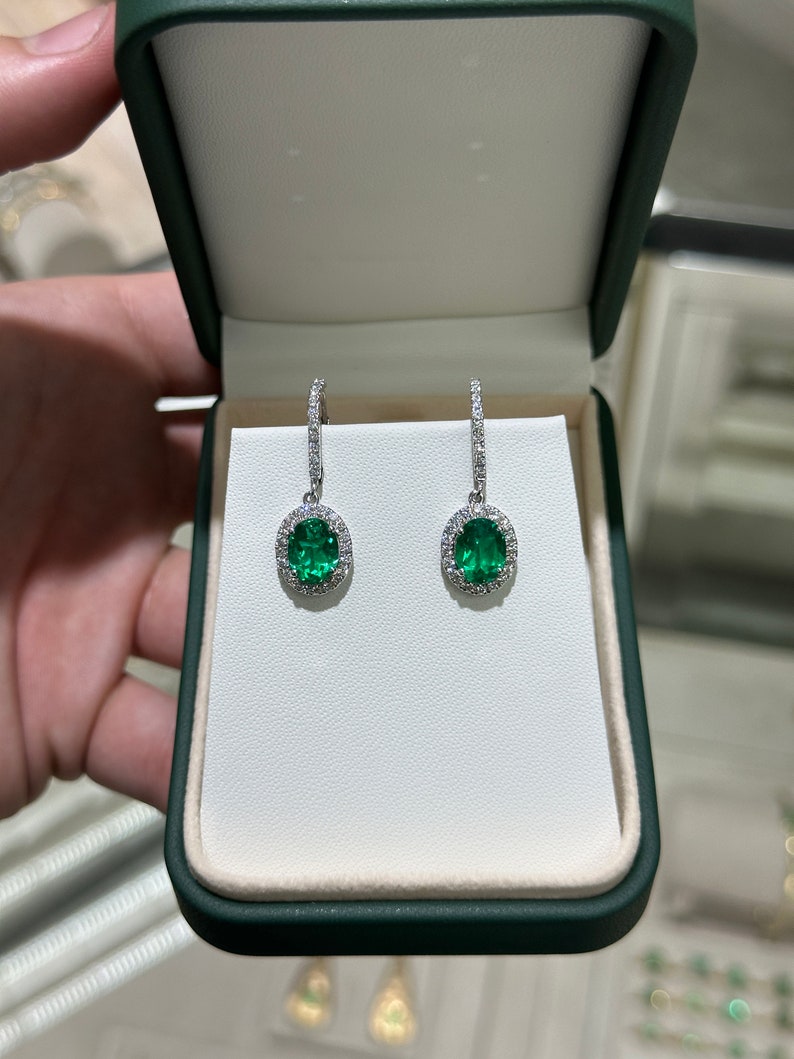 Colombian Emerald 14K white gold dangle earrings with lab-created emeralds and diamonds, featuring intricate jewelry design.