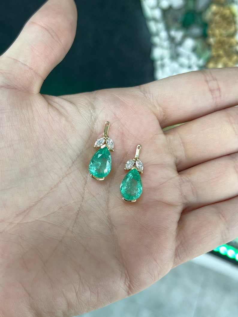 Colombian Emerald earrings with pear-cut green teardrop emeralds and marquise diamonds in floral earring jacket design.