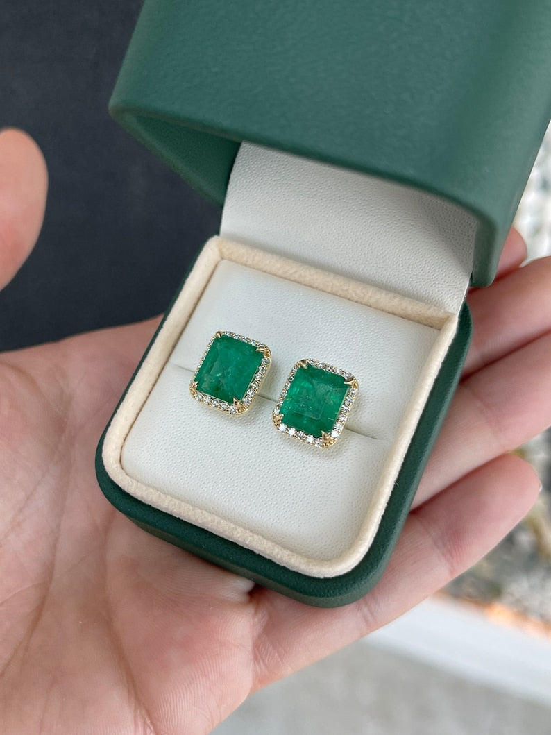 14K gold emerald and diamond halo stud earrings featuring lush dark green natural emeralds and round diamonds.