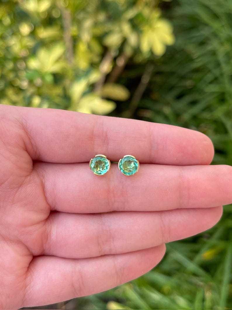 14K Colombian Emerald round stud earrings with 2.0tcw semi-bezel setting, featuring vibrant green emeralds and gold posts.