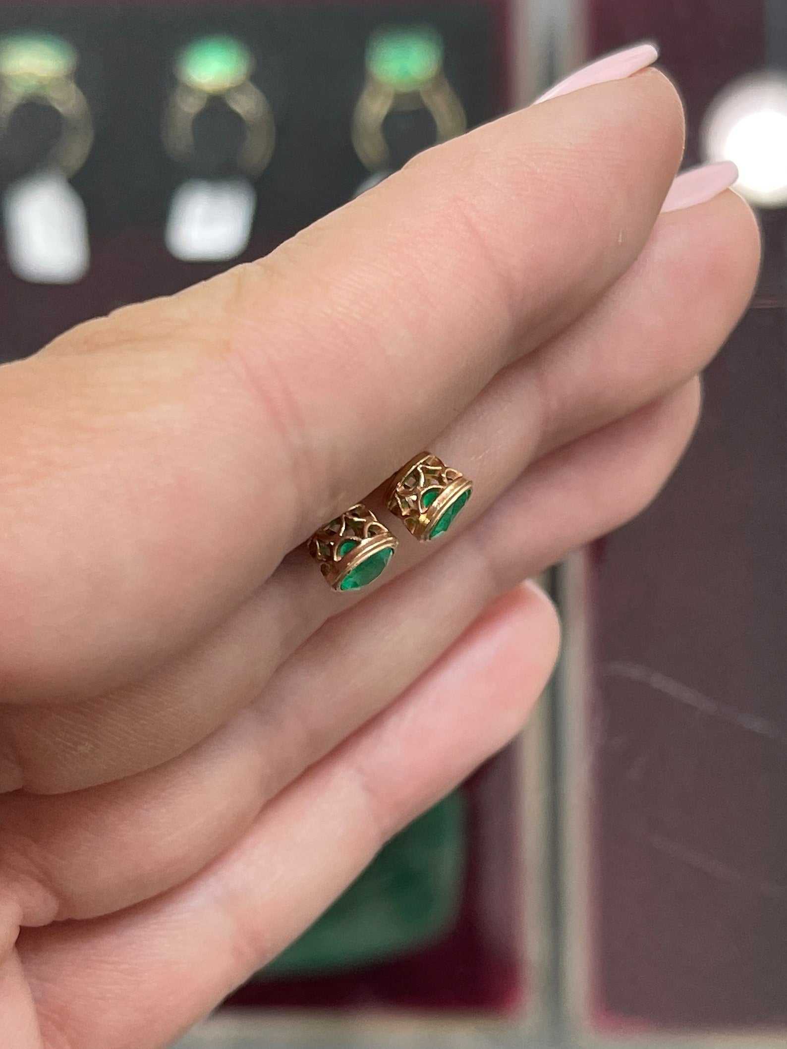 Colombian Emerald 14K yellow gold stud earrings with round-cut, bezel-set rich green emeralds, 1.40tcw total weight.