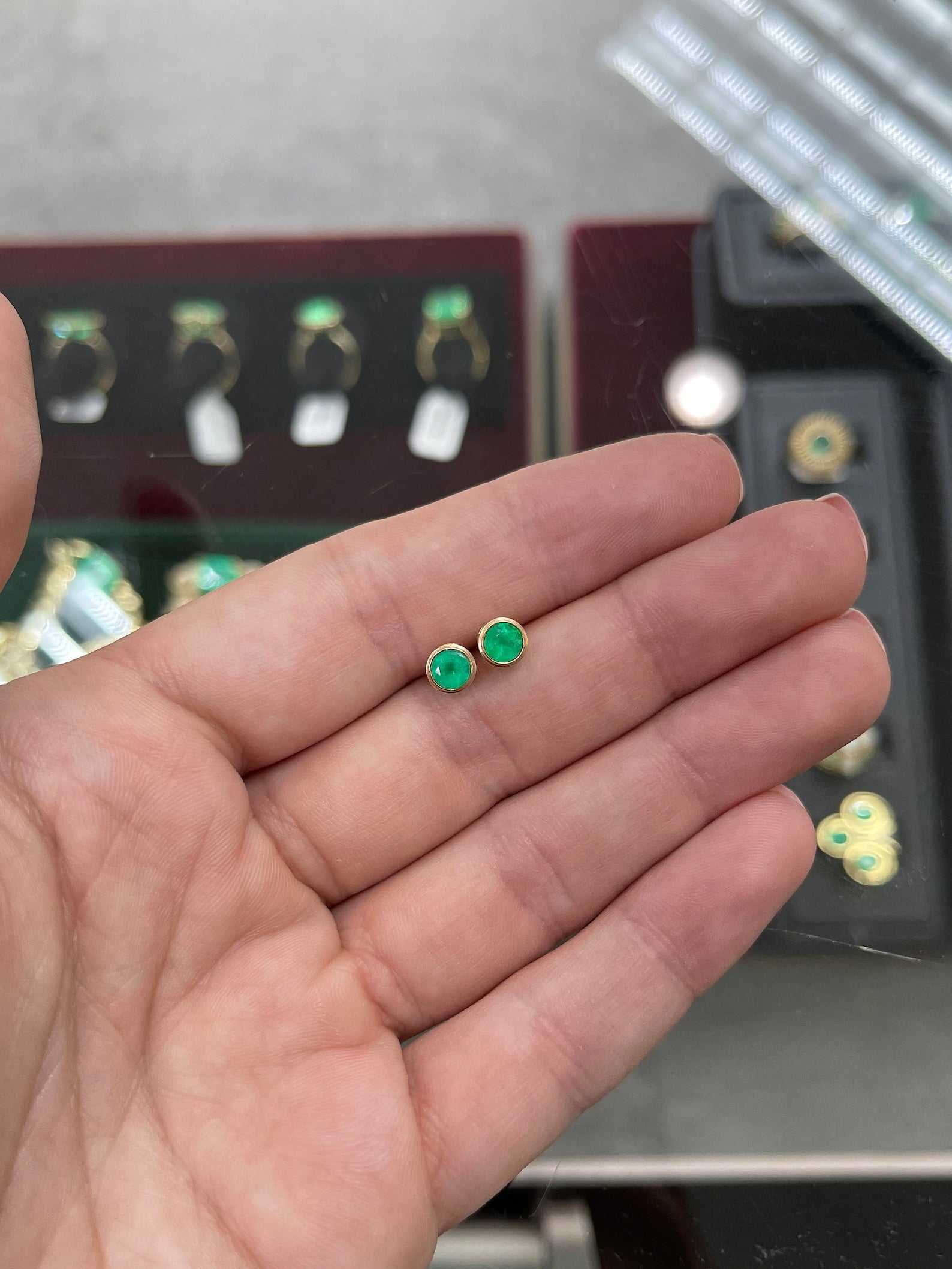Colombian Emerald 14K gold stud earrings with round-cut rich green emeralds, bezel-set, 1.40 carats total weight.