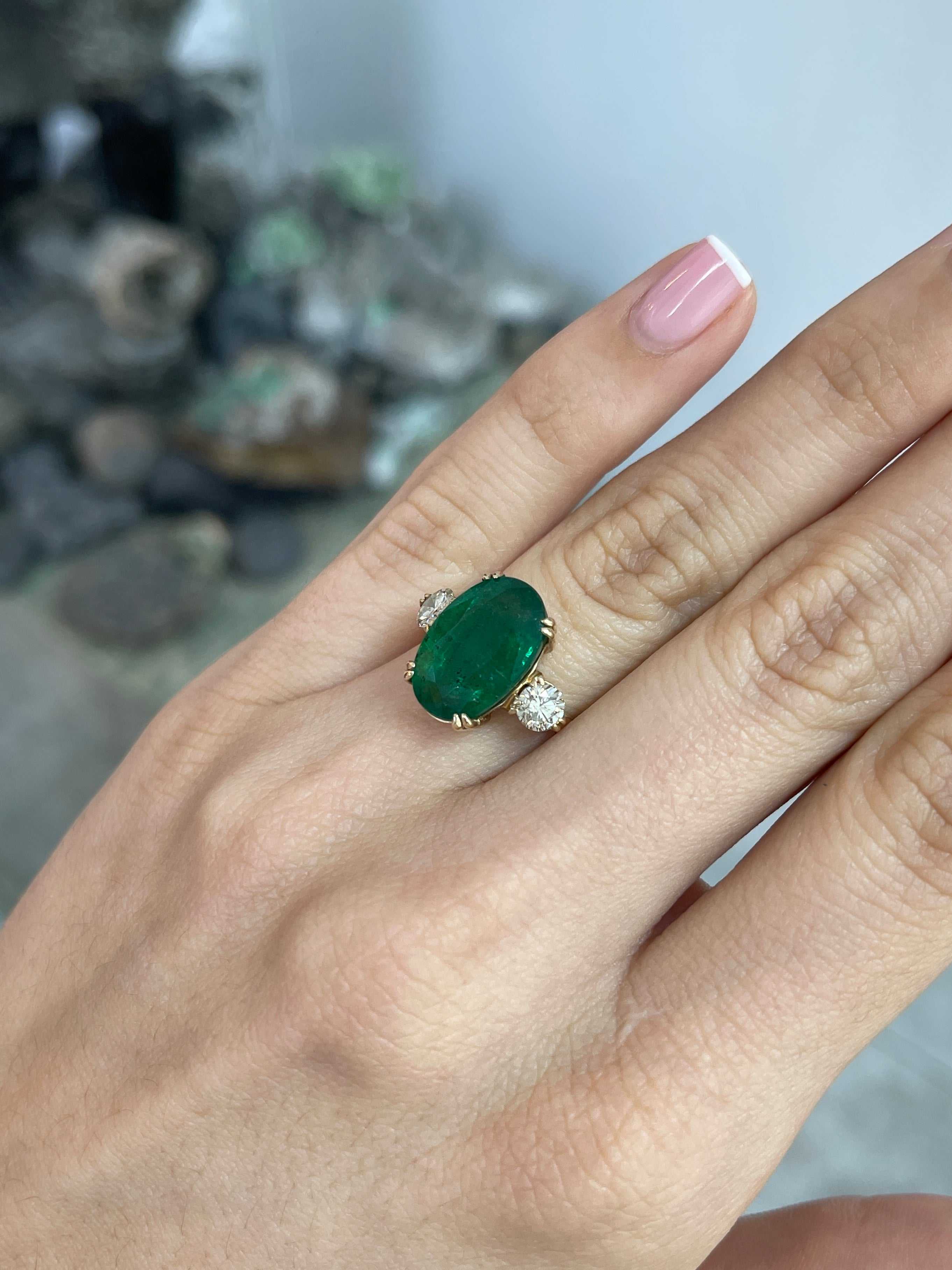 Dark green oval emerald and round diamond 3-stone engagement ring in 14K gold, featuring double prong settings by Colombian Emerald.