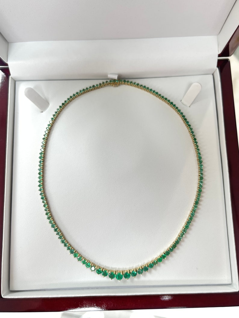 Colombian Emerald tennis necklace with 22.0 tcw, vivid medium dark green round emeralds, 14K yellow gold chain.