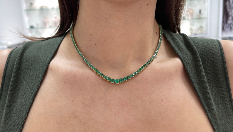 Colombian Emerald tennis necklace featuring graduating vivid medium dark green round emeralds in 14K yellow gold chain.